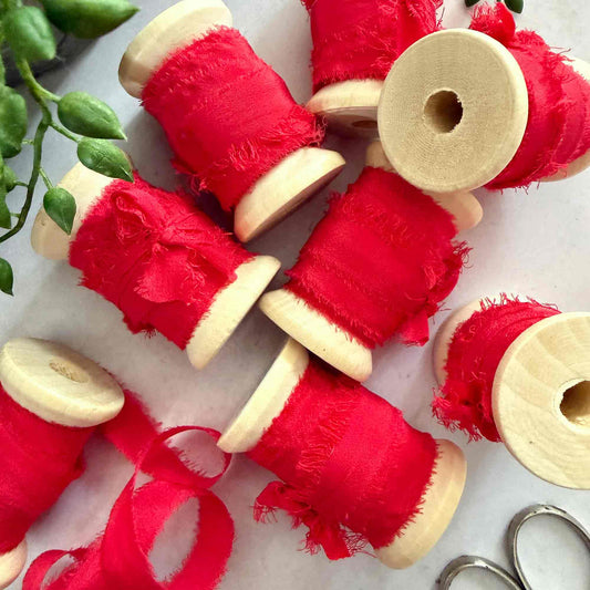 Berry Red frayed edge silk ribbon on wooden spools for weddings and crafts