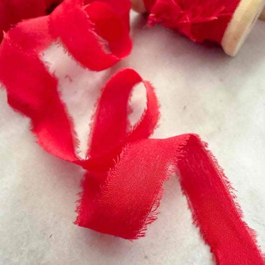 10mm Berry Red silk ribbon with softly frayed raw edges