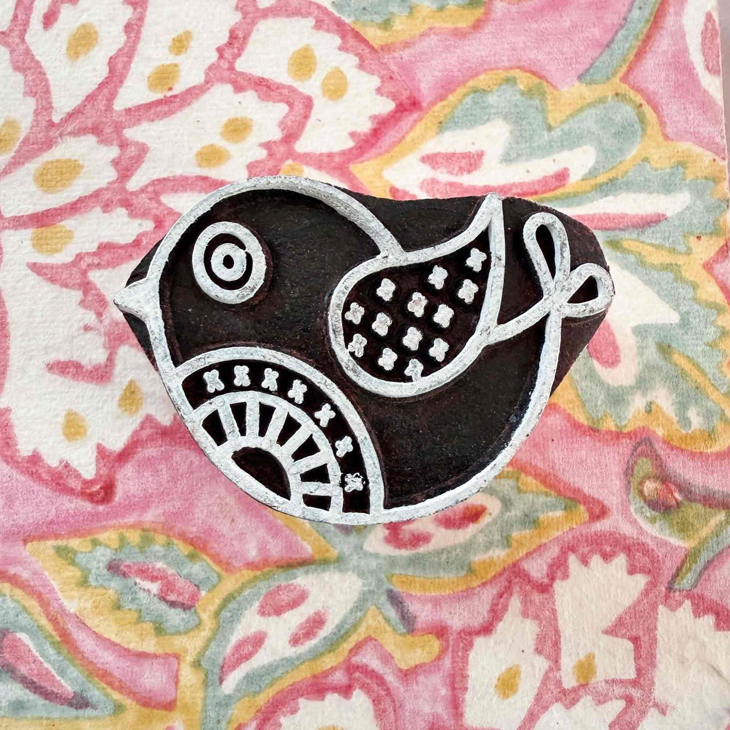 cute bird design wooden stamp on a wood block pattern background