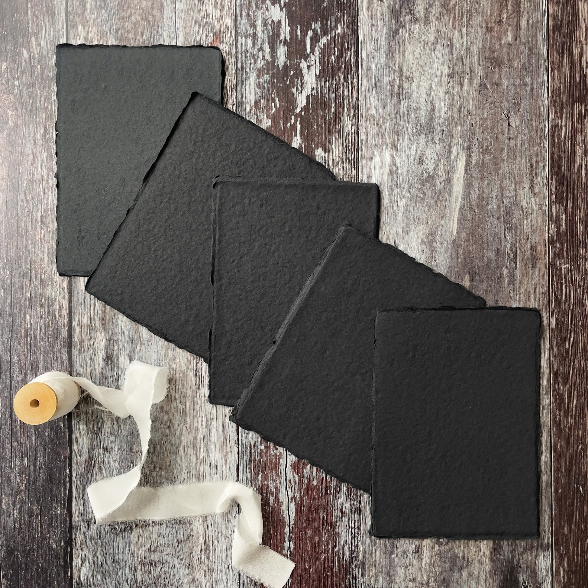 Black handmade recycled paper and card with a deckled edge.  By The Natural paper Company