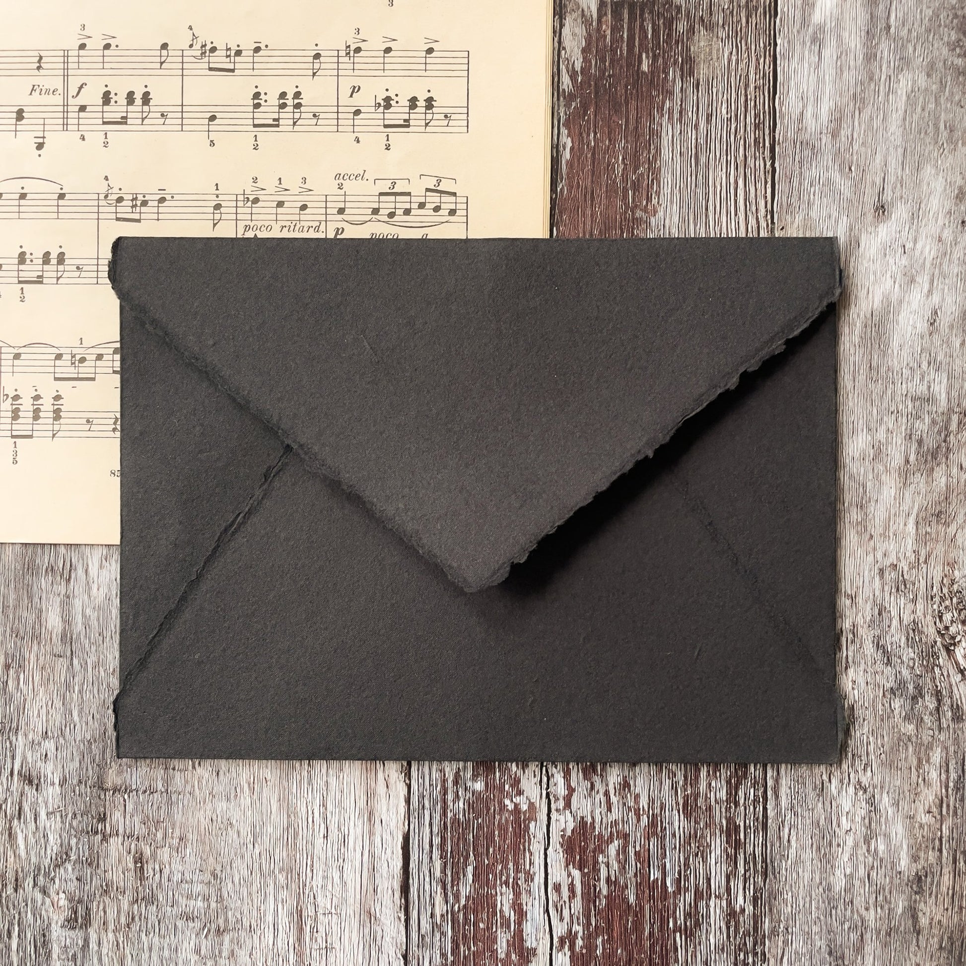 Black invitation envelope handmade from recycled cotton rag paper.  Deckle edge handmade paper envelopes in black.  By The Natural paper Company