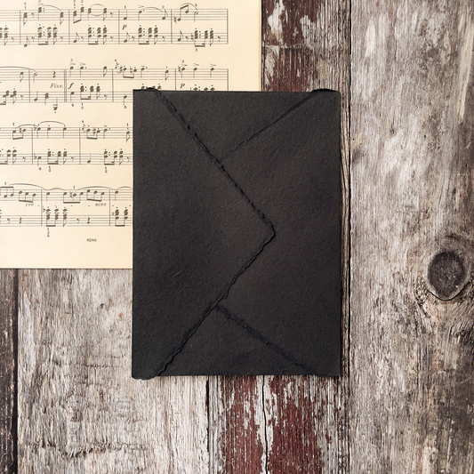 black handmade paper envelope with pointed flap and deckled edge.  Perfect size envelope for invitations