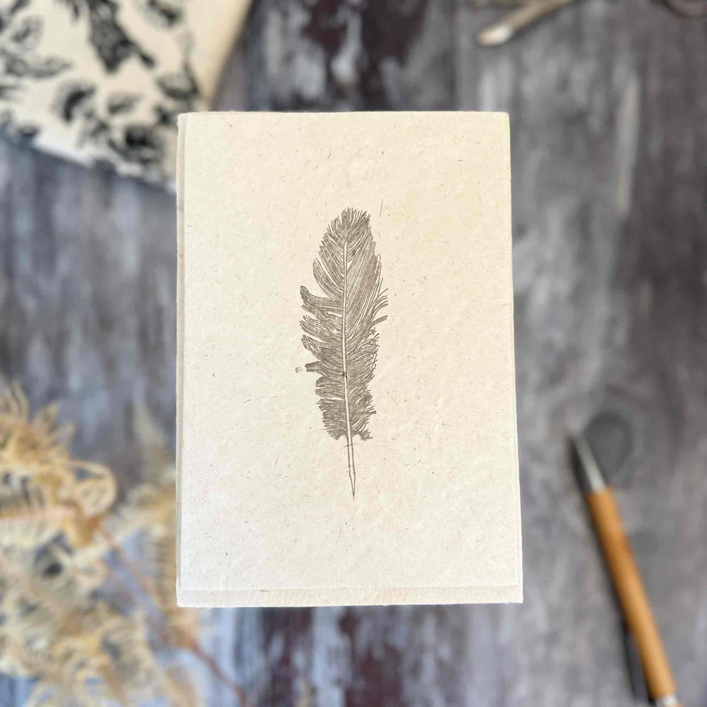 Natural textured Lokta paper notecard featuring delicate Plume feather print, eco-friendly stationery