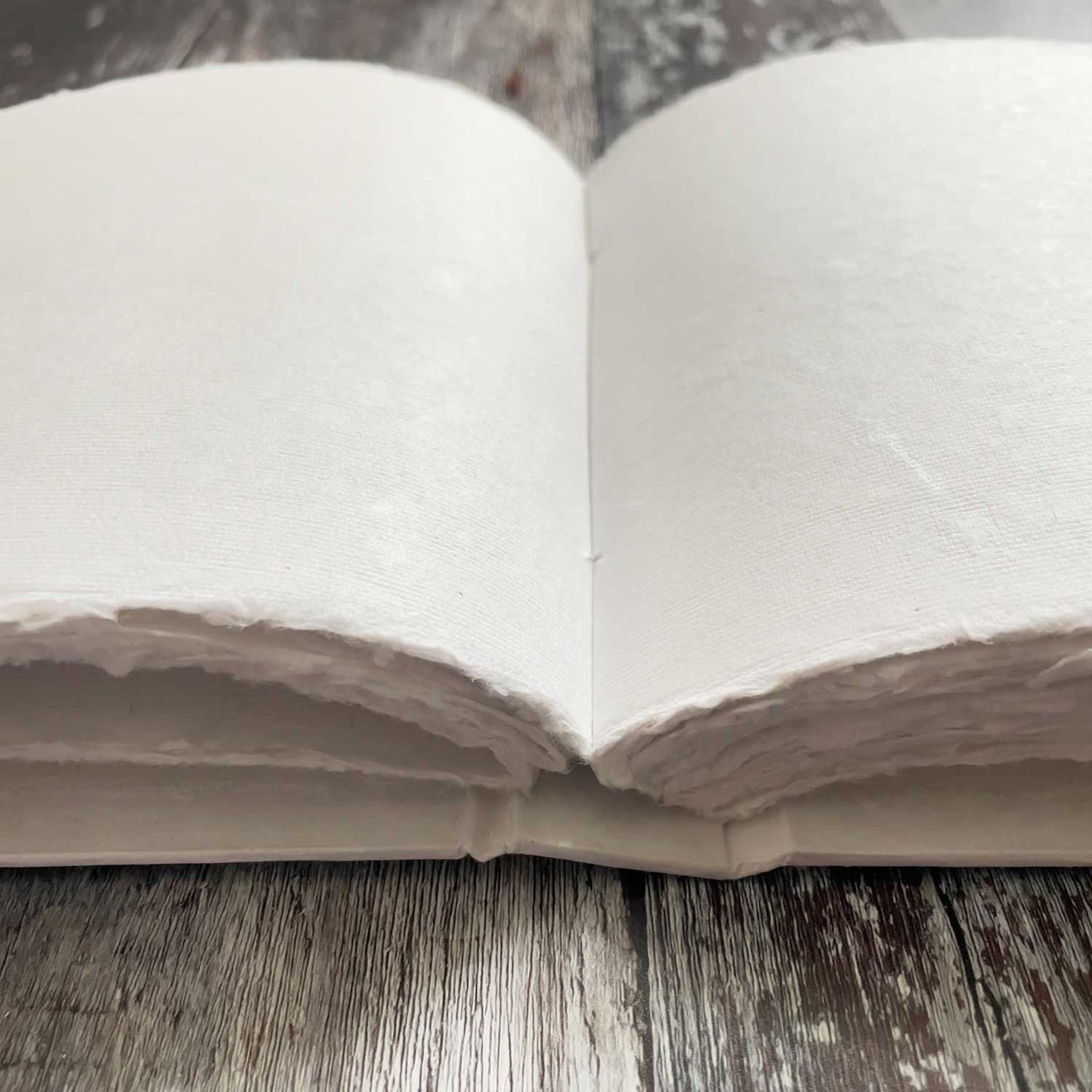 Blank white book made from handmade paper with deckled edges.  Beautiful blank book for making wedding guest books, personalised journals personalised notebooks and more.  Also suitable for use as an artists journal.  By The Natural Paper Company