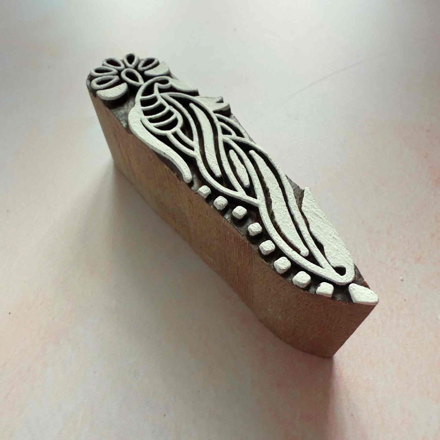 hand made wood block stamp with a stylised floral pattern.