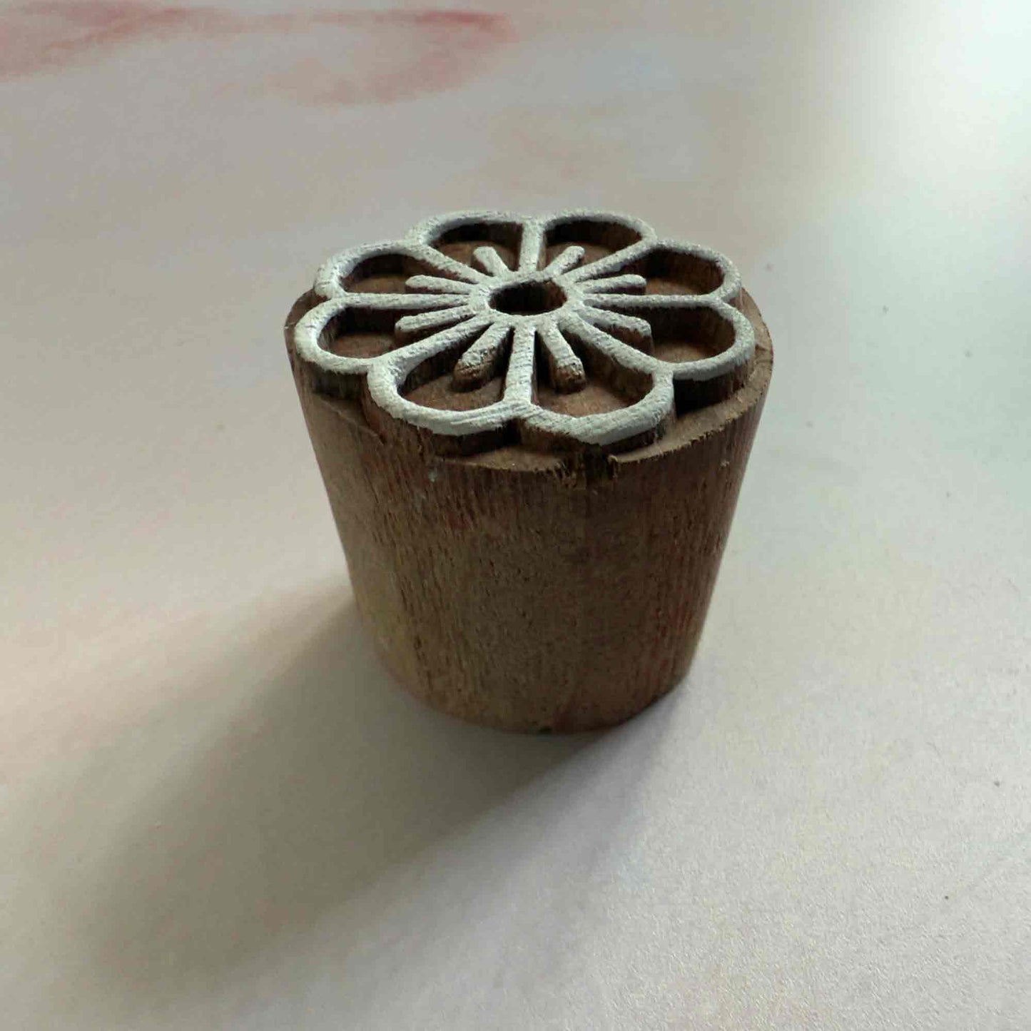 hand made wood block stamp with a flower pattern.