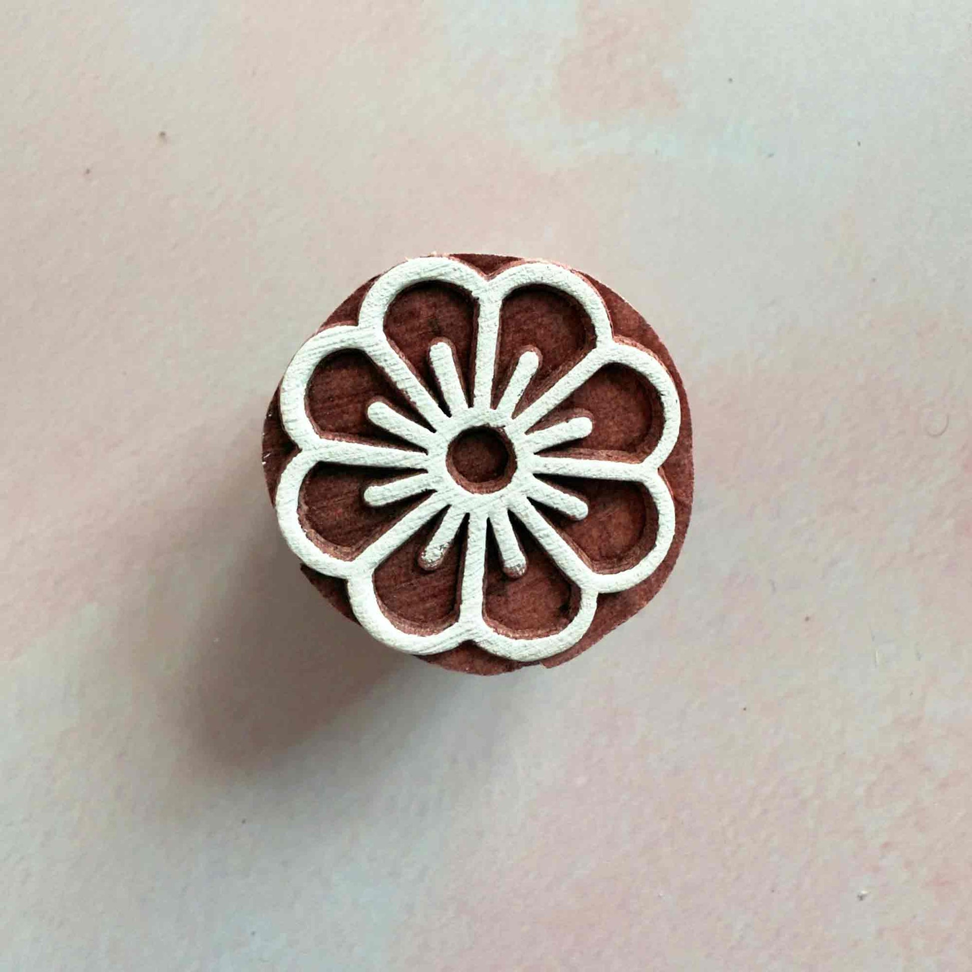 A small wood block stamp with a flower design.  Add a pretty floral pattern to your cards, gift wrapping or fabric