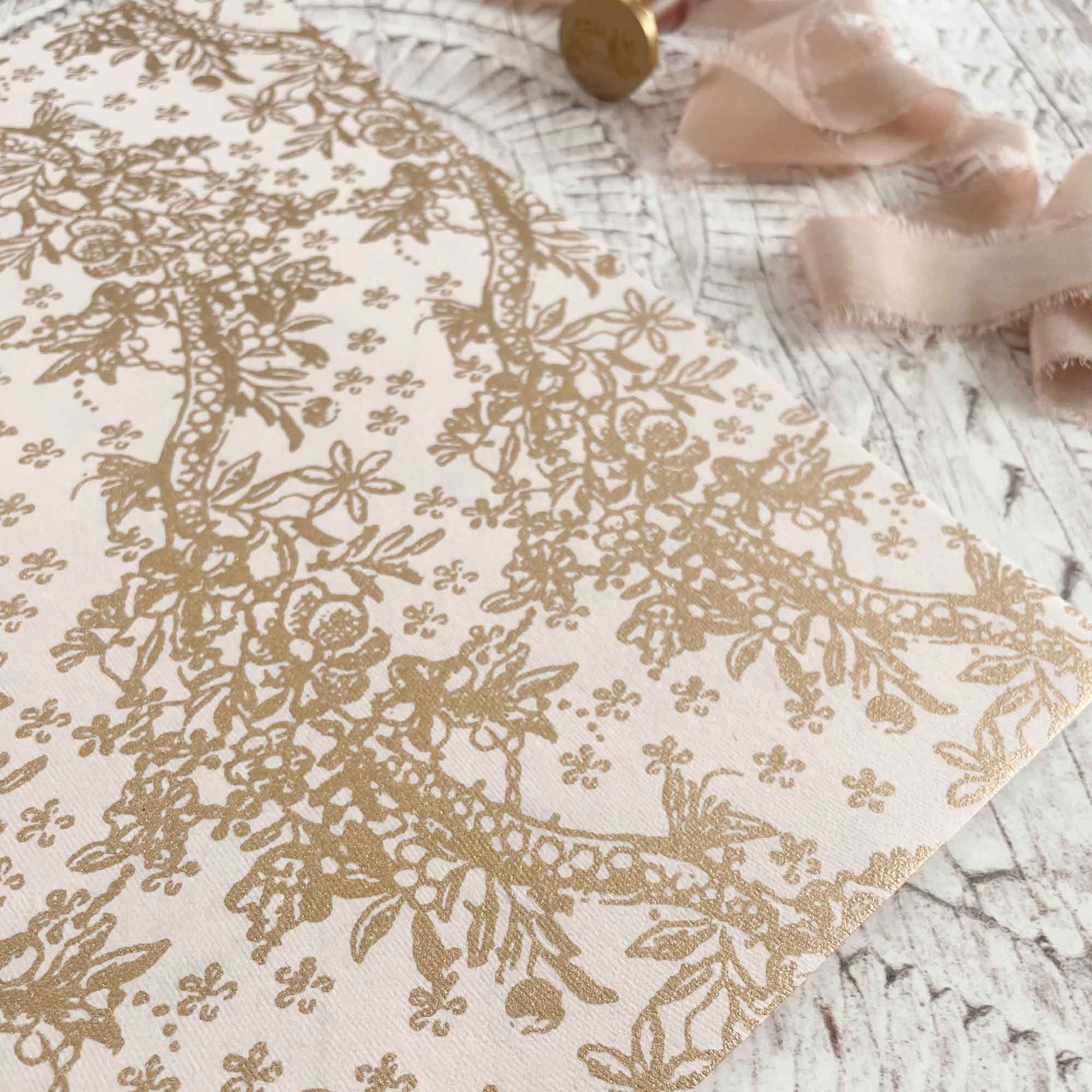 blush pink recycled cotton paper with gold flowery pattern