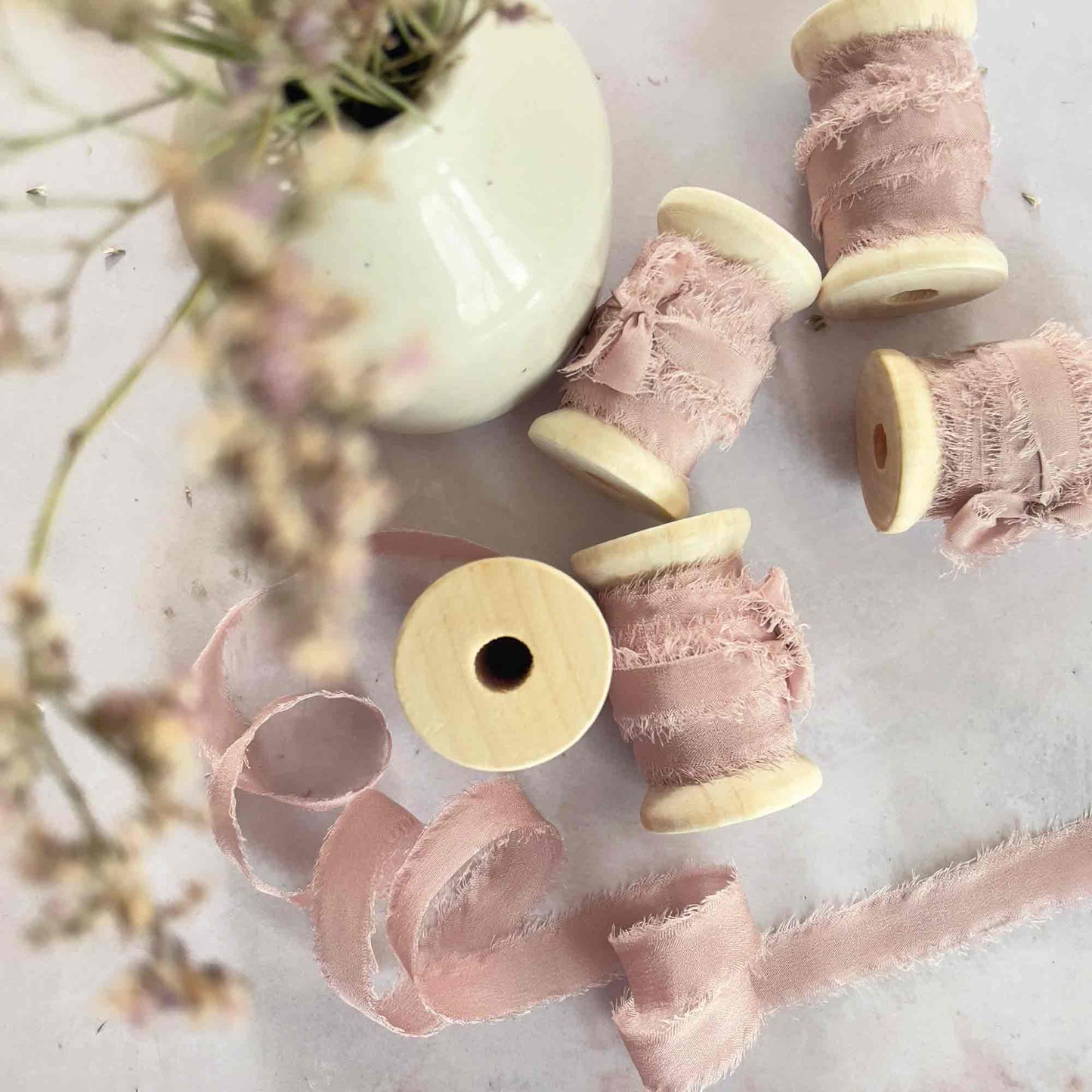 Blush pink ribbon on a wooden reel.  1cm narrow pure silk ribbon by The Natural Paper Company