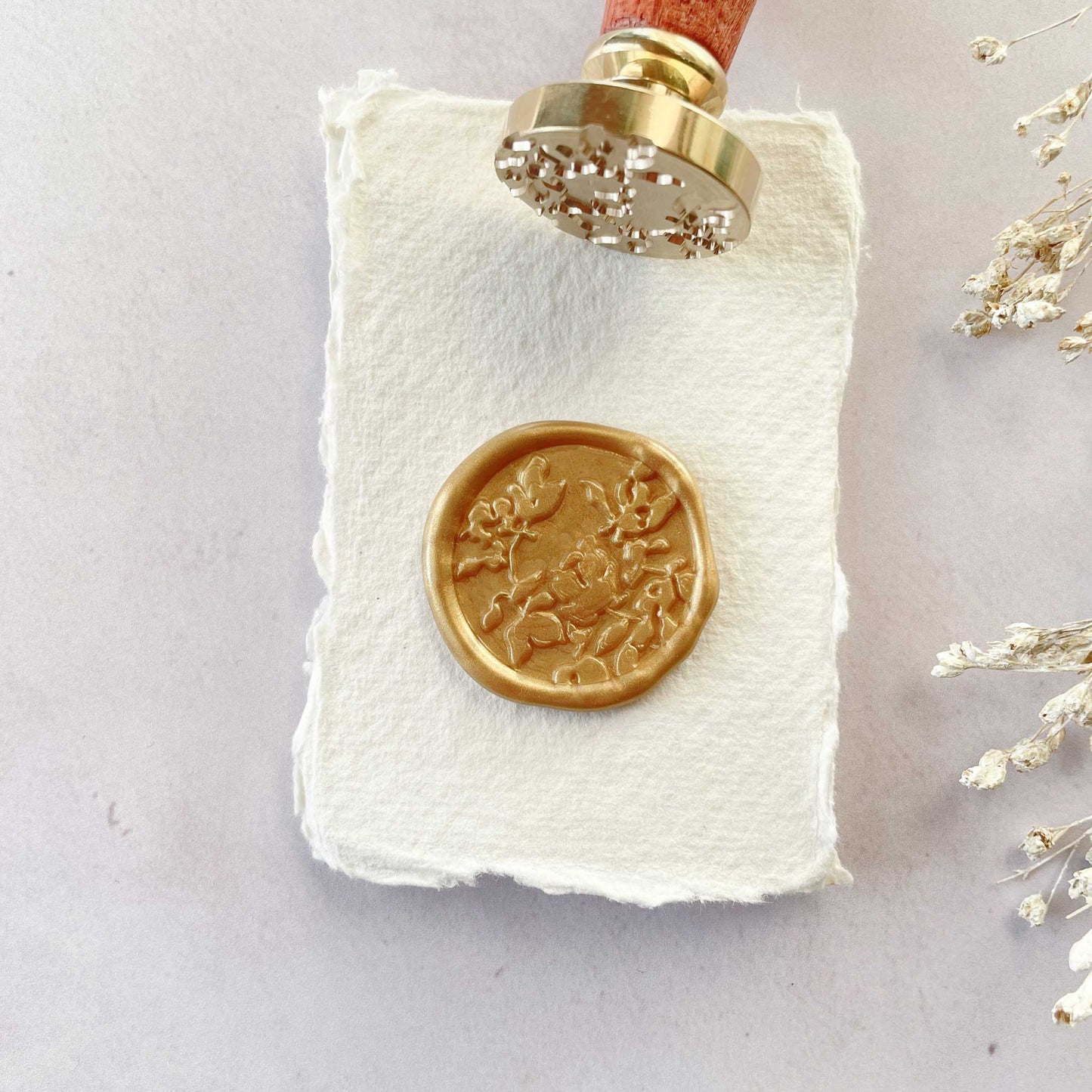 Botanica Wax Stamp with a floral pattern.  Make Flowery wax seals with this pretty stamp by The Natural Paper Company.  Combine with your choice of sealing wax to make wax seals for wedding invitations, stationery, gift packaging and more