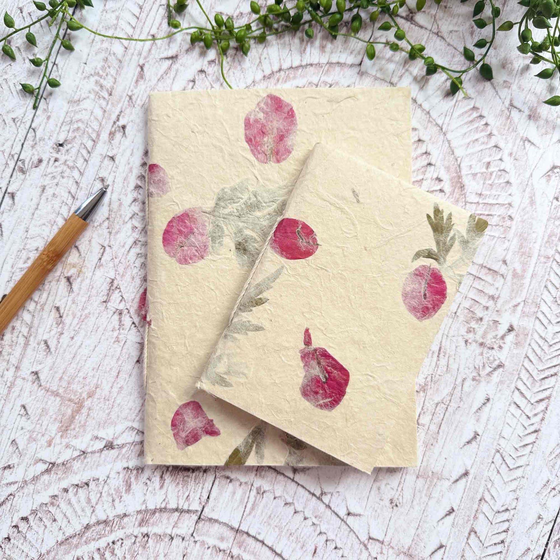 Two Lokta paper notebooks in A5 and A6 sizes, featuring real Mugwort leaves and Bougainvillea petals, handmade in Nepal
