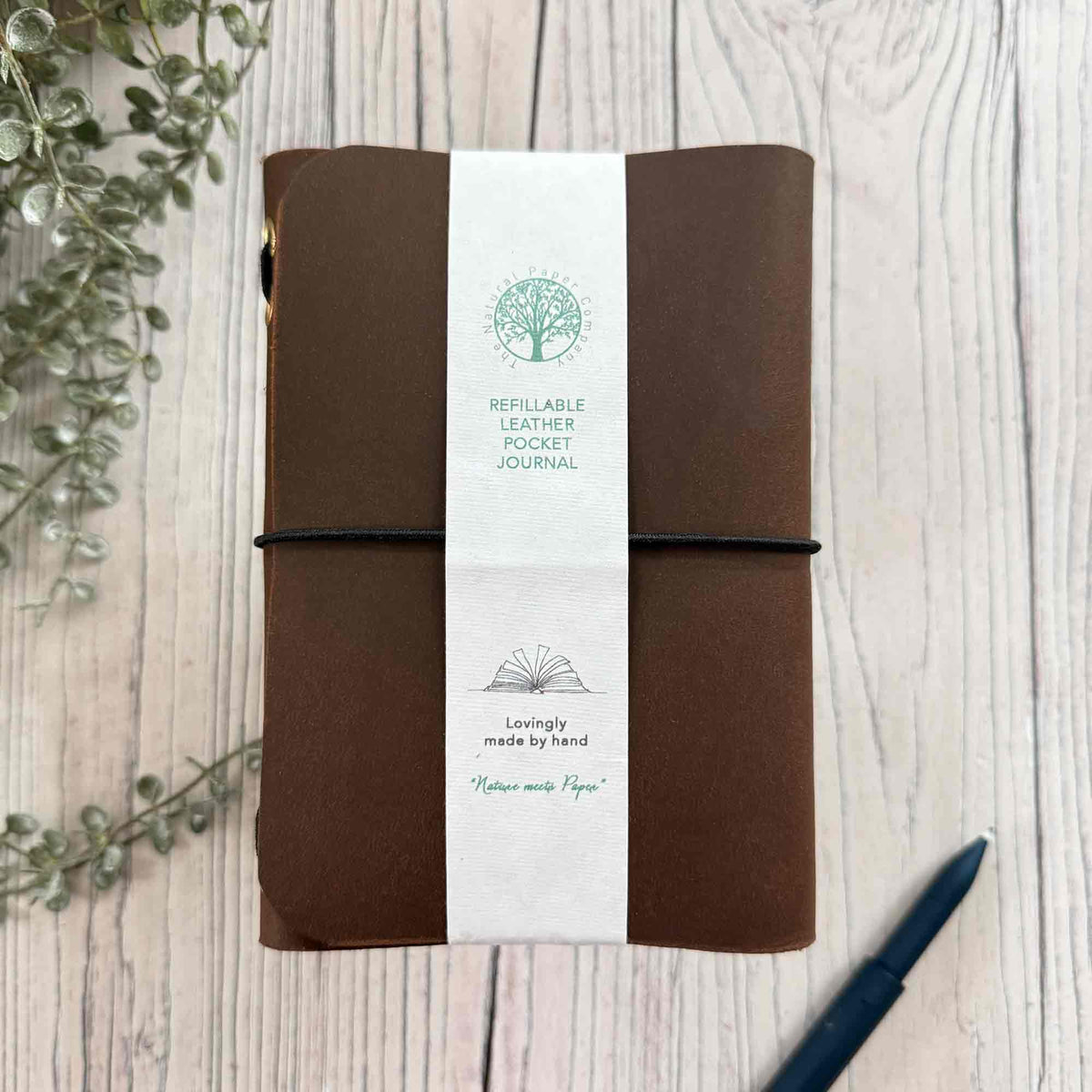 Handmade brown refillable leather journal with paper band and elastic closure