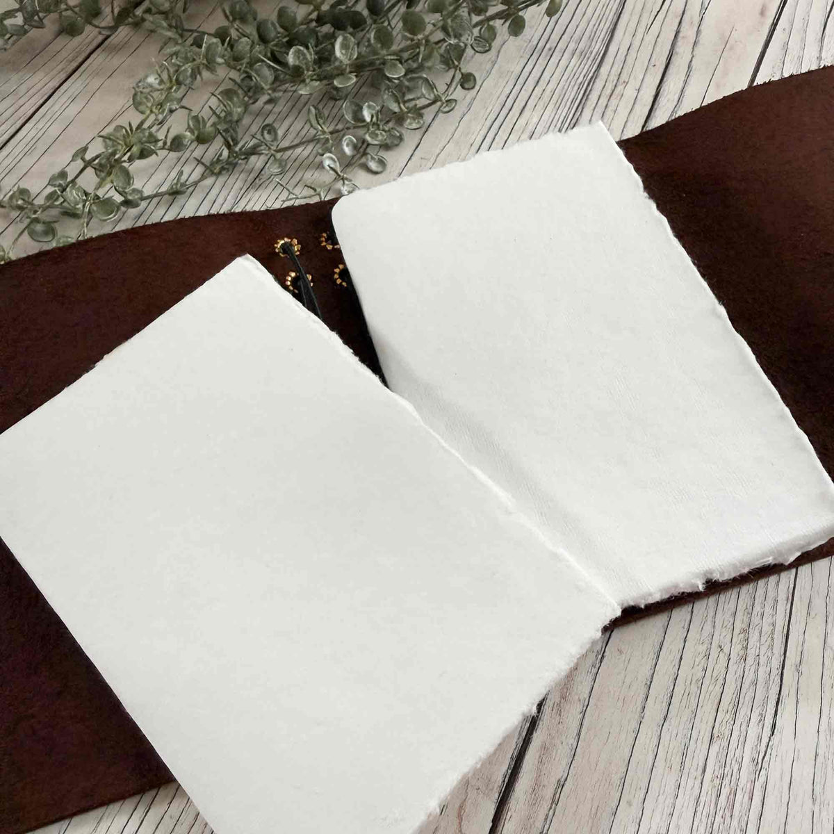 Open brown A6 refillable leather journal with handmade cotton paper inserts