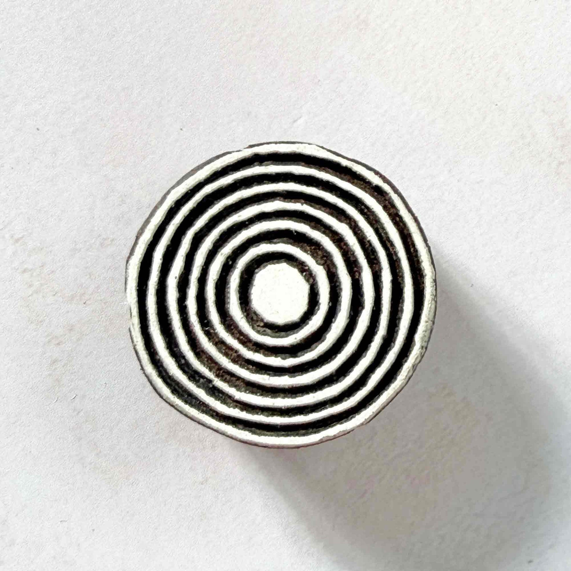 Indian wood block stamp — Bullseye Small design, seven fine concentric circles face-on view on soft pale background, delicate ring motif hand-carved wooden stamp, authentic traditional printing block from India