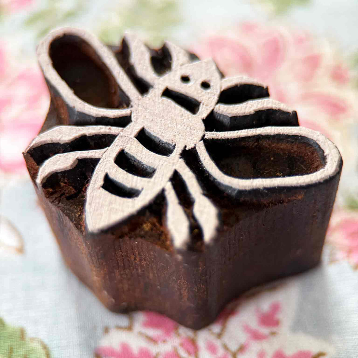 Bumble Bee Indian wooden printing block displayed on block printed fabric