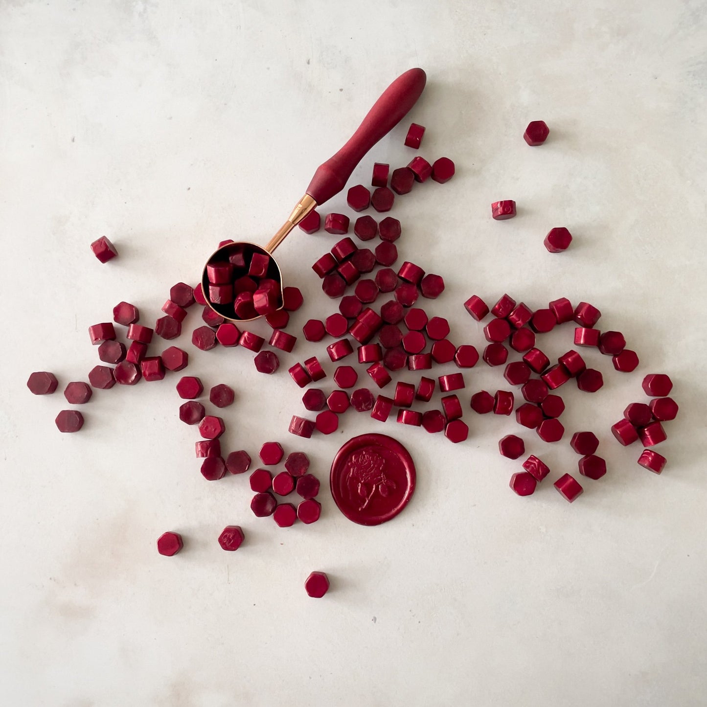 Burgundy sealing wax beads to make wax seals.  Use our eco friendly sealing wax to decorate your wedding invitations, stationery, gift wrap and more.  by The Natural Paper Company 