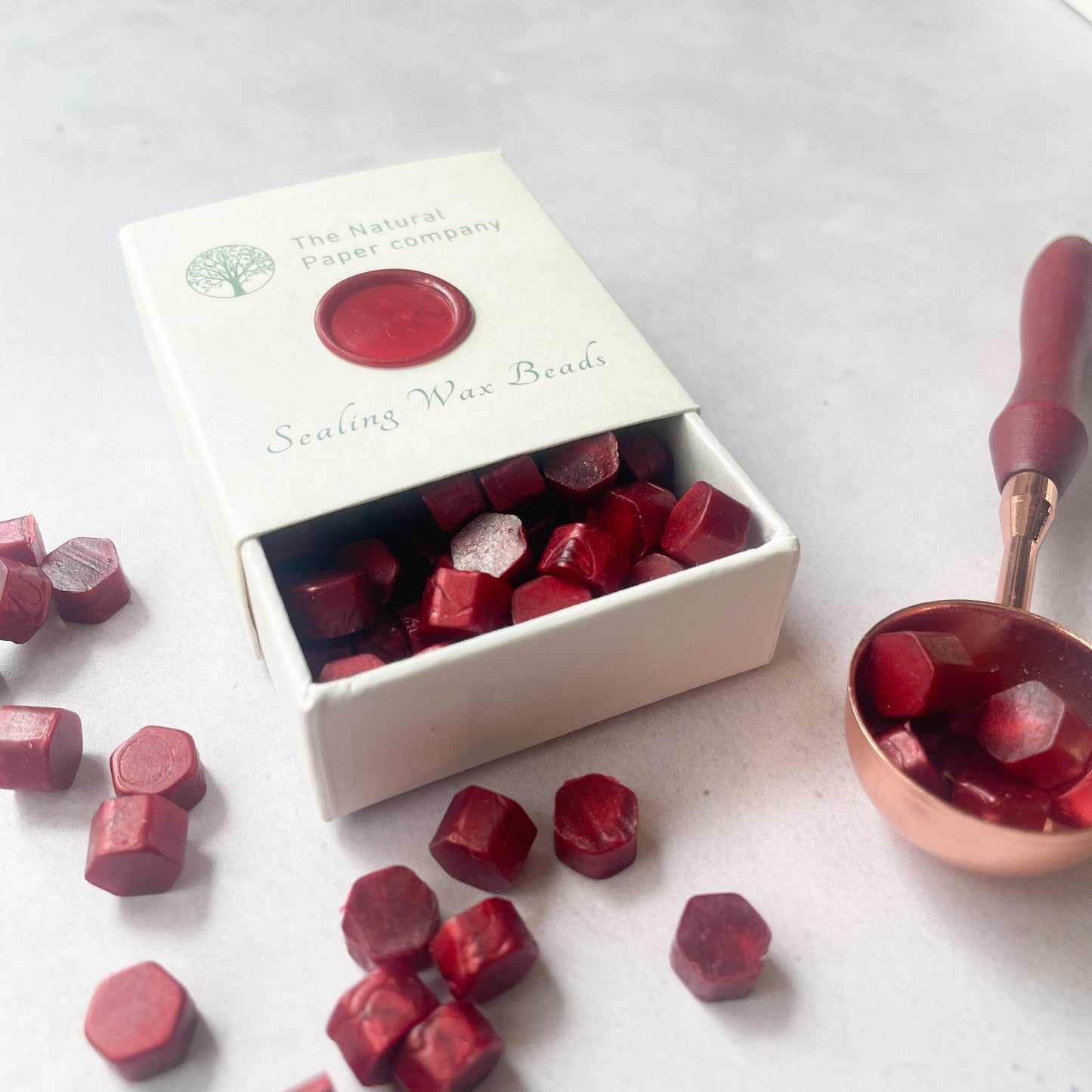 Burgundy sealing wax beads to make wax seals.  Eco friendly wax without plastic, paraffin free and biodegradable.  By The Natural paper Company