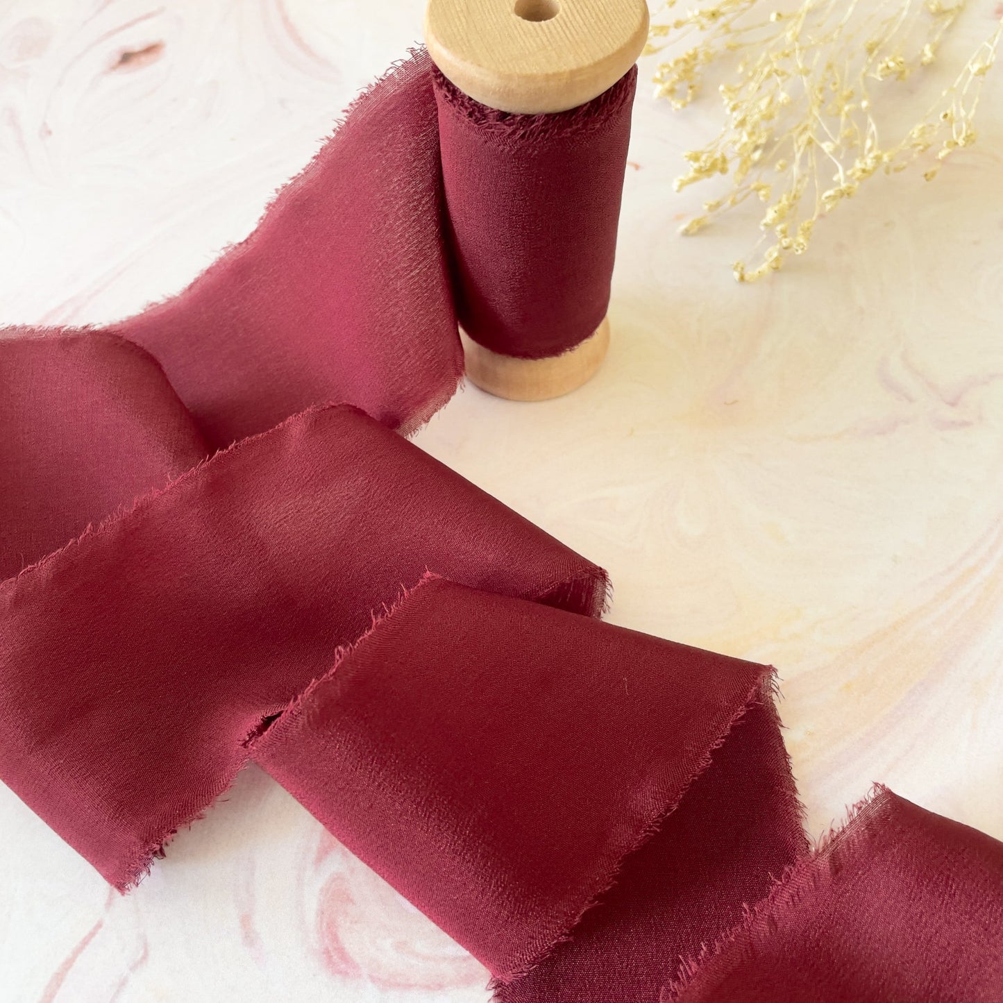 Silk ribbon in burgundy.  Fine silk ribbon for floristry and decorating wedding invitations.  By The Natural Paper Company.