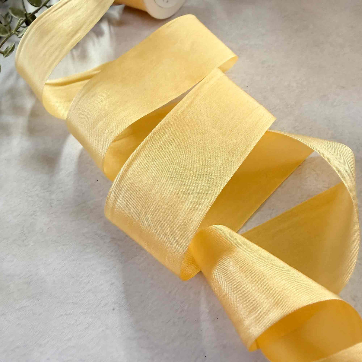 32.5mm Buttermilk Silk Ribbon in a delicate lemon yellow shade for weddings, gifts, and floristry.
