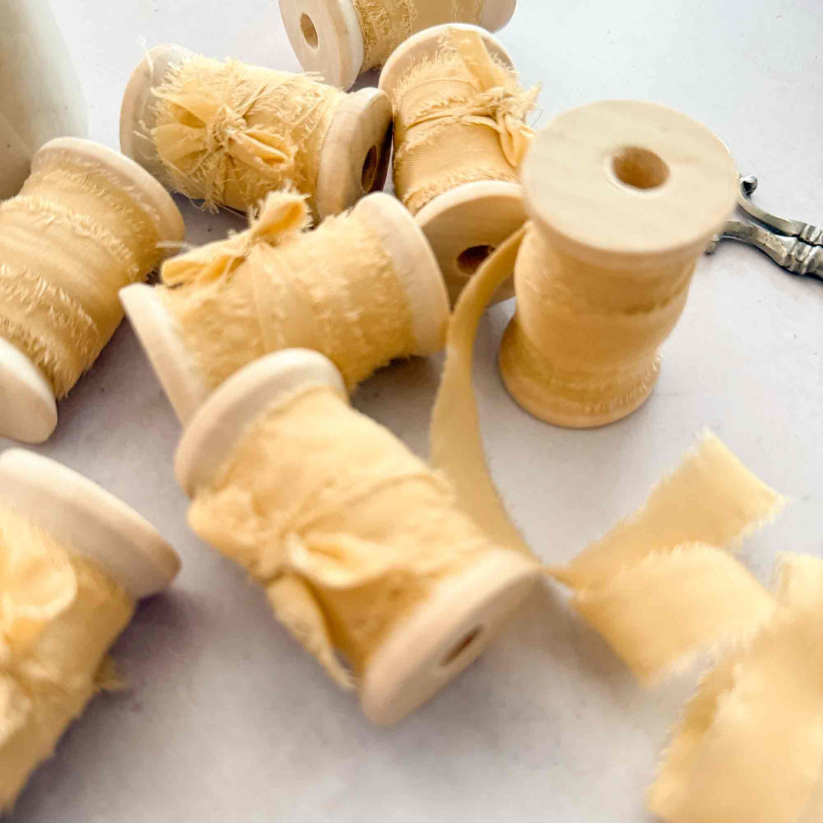 Buttermilk Habotai silk ribbon 10mm wide wound onto wooden reels