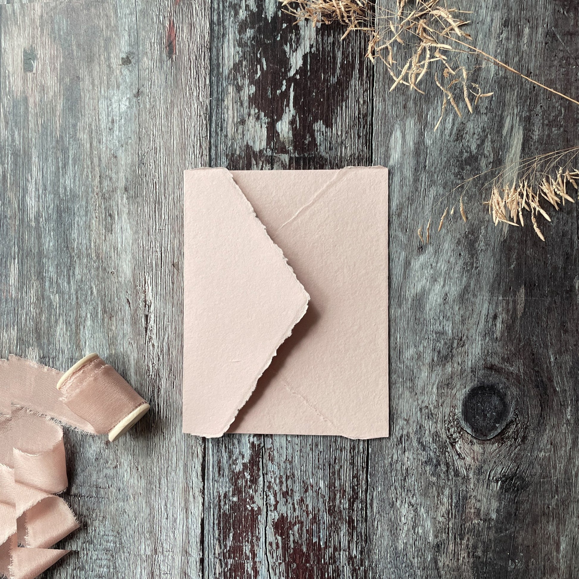 Invitation envelopes made from handmade recycled paper with a deckle edge pointed flap.  Blush pink handmade envelopes.  By The Natural Paper Company