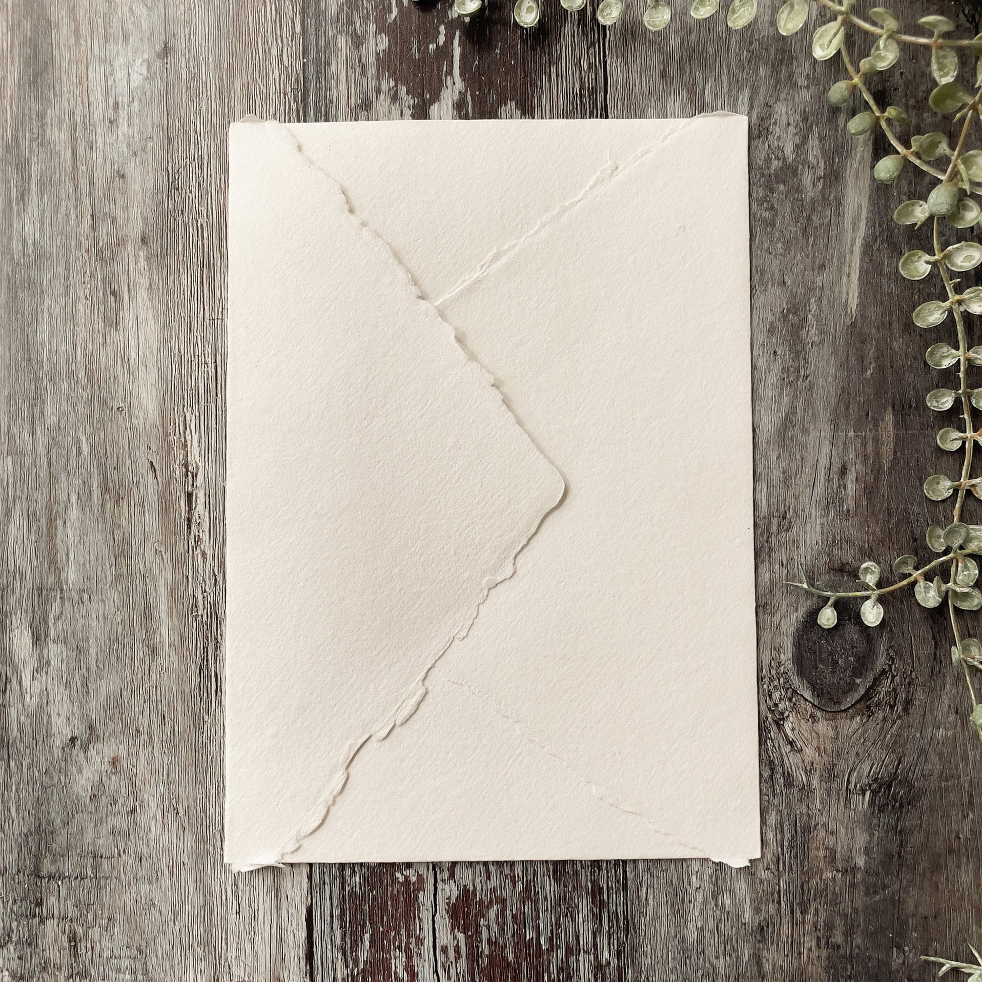 C6 invitation envelopes handmade from recycled paper.  White recycled paper envelopes with a deckle edge pointed flap.  By The Natural paper Company