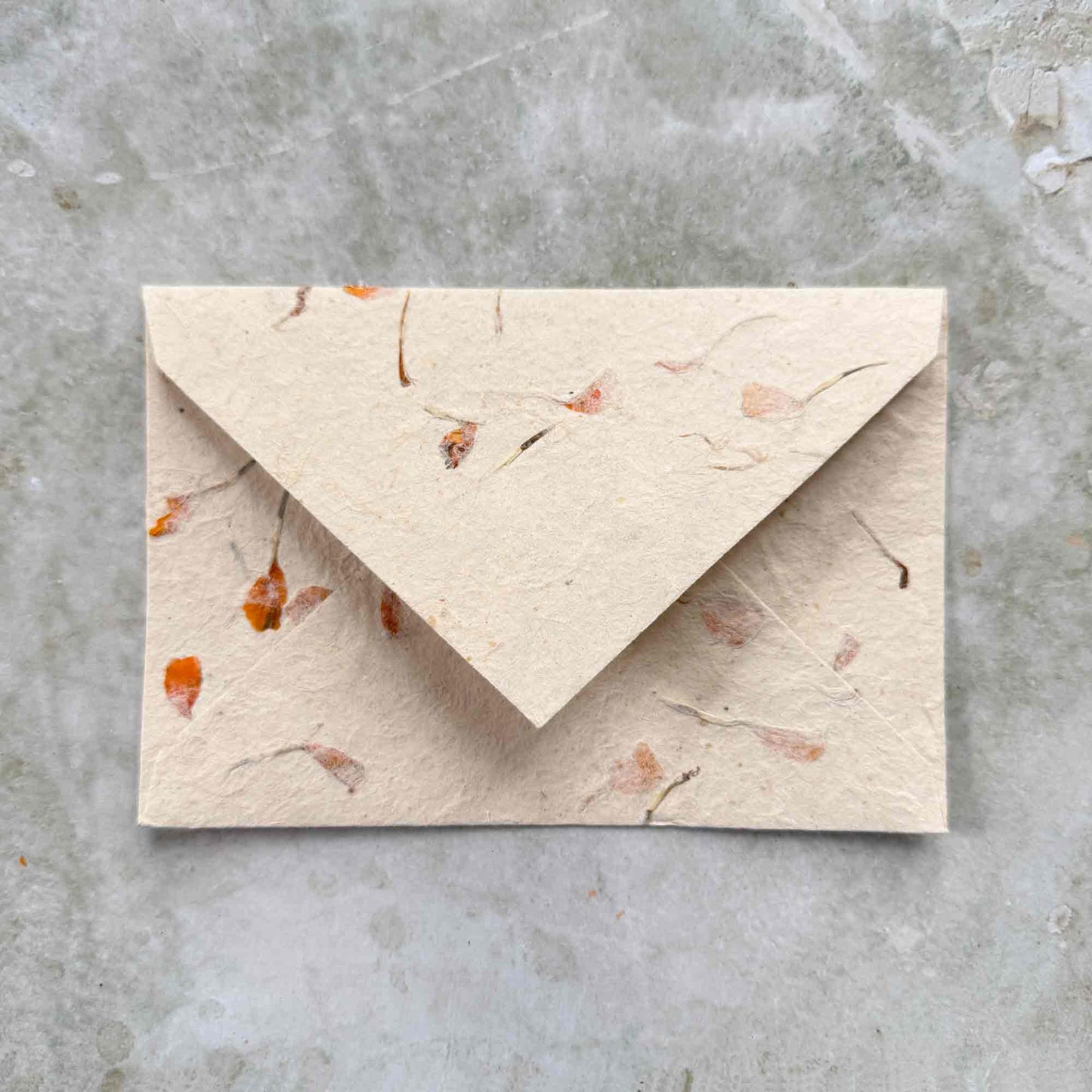 handmade paper envelope with marigold flowers