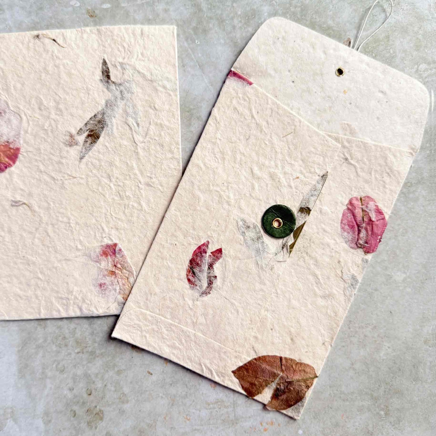 washer and string envelopes made from handmade lokta paper with petals