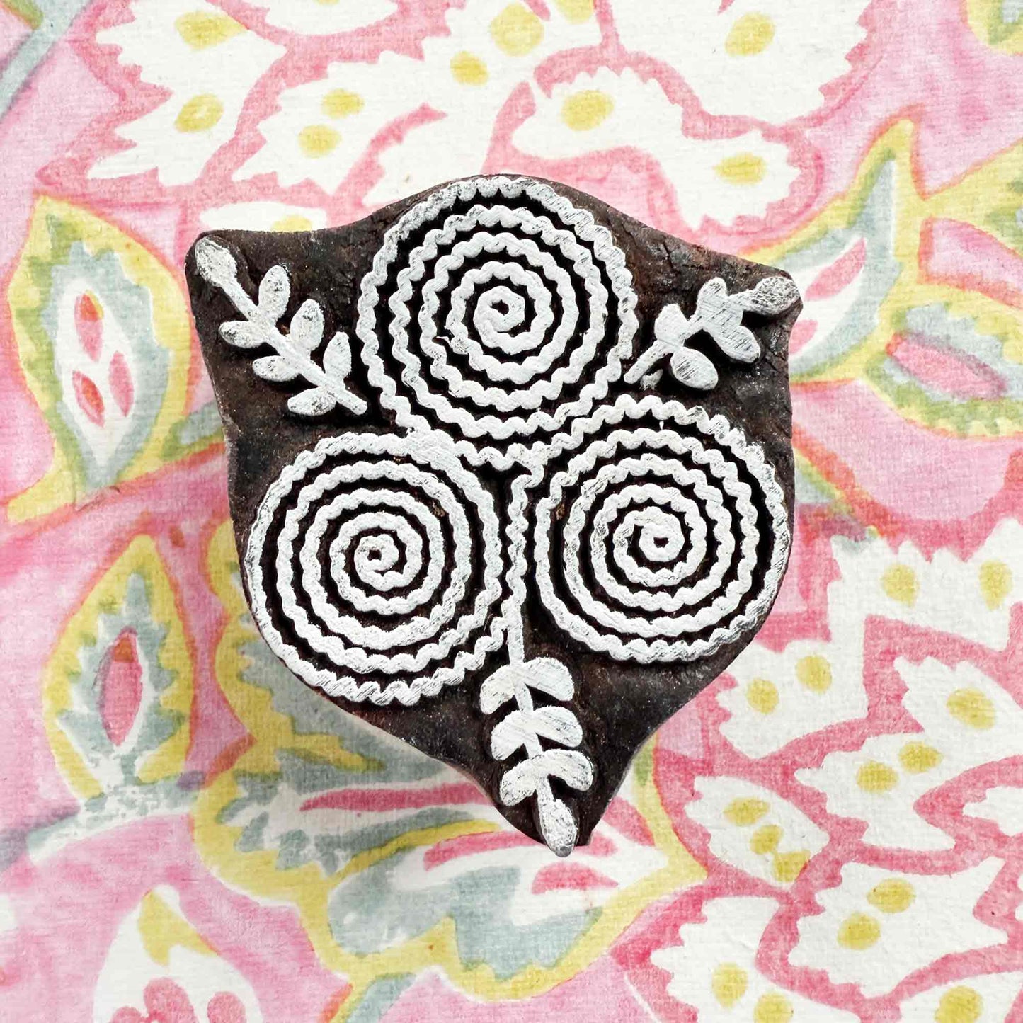 indian wood block stamp with a stylised flower pattern
