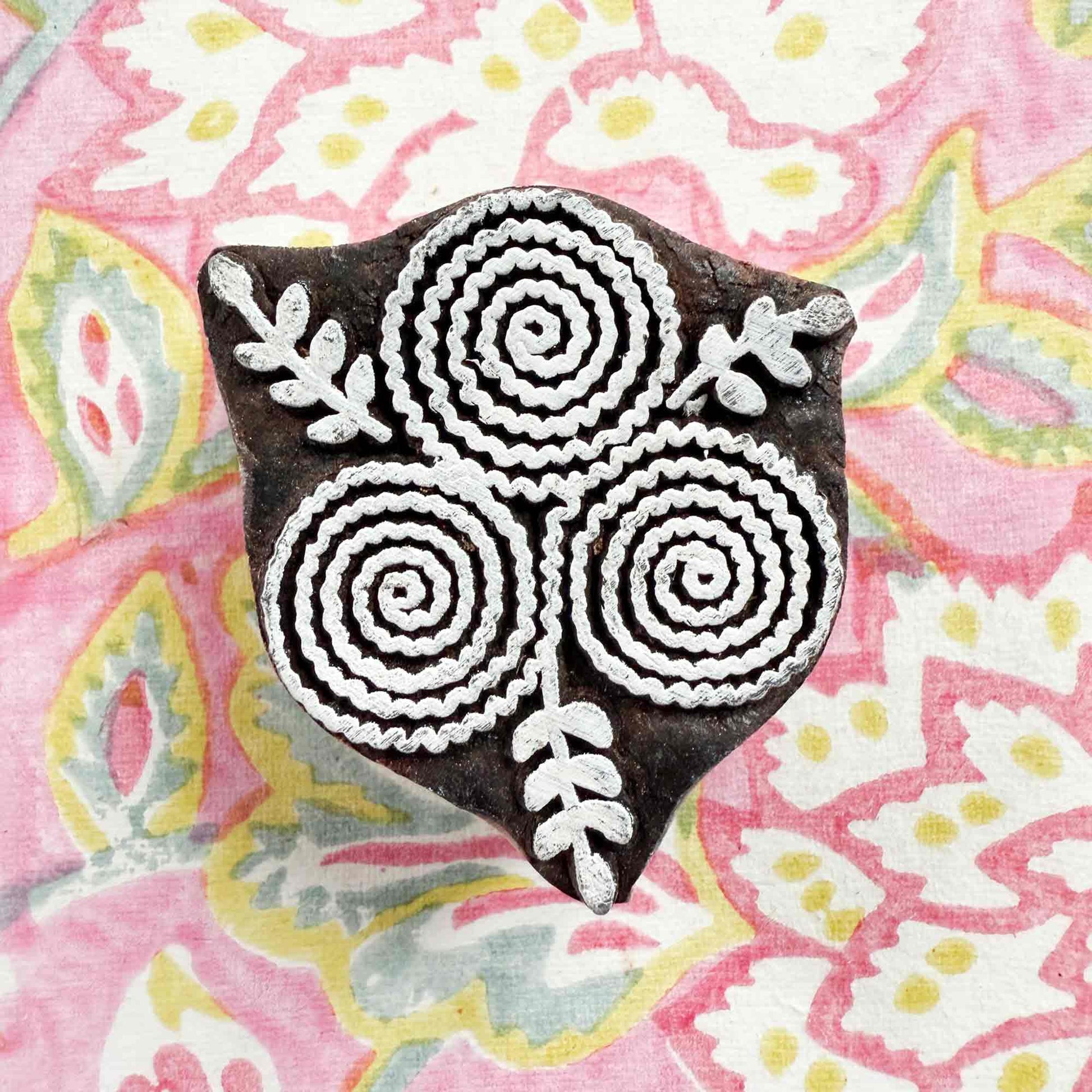 indian wood block stamp with a stylised flower pattern
