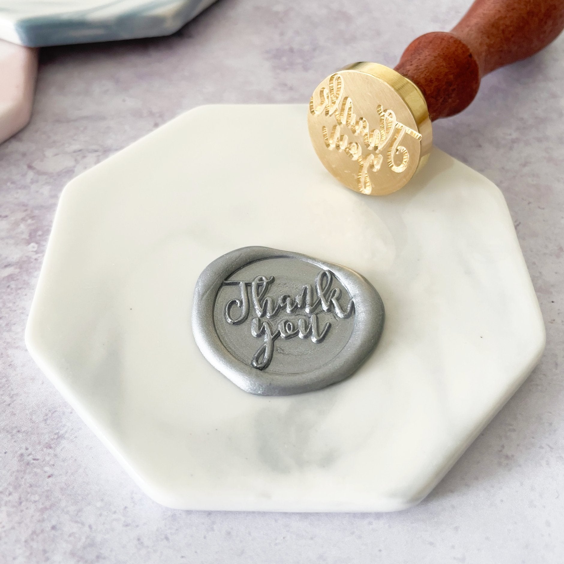 Hexagon shape wax seal mat in grey and white marble finish.  Ceramic Wax stamping mat by The Natural Paper Company