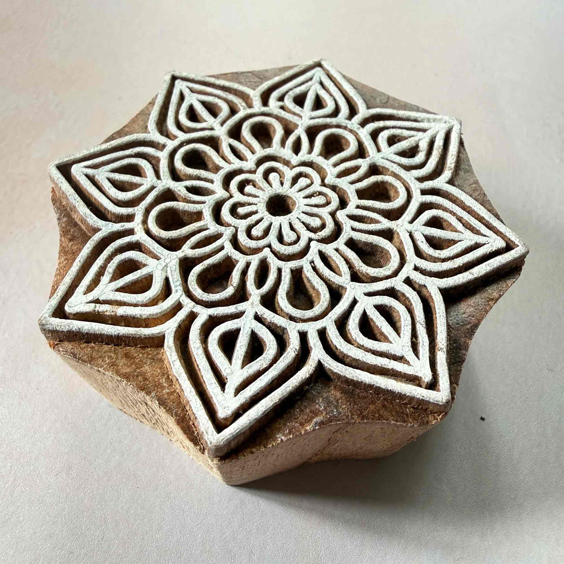 Wooden block with a geometric floral design 