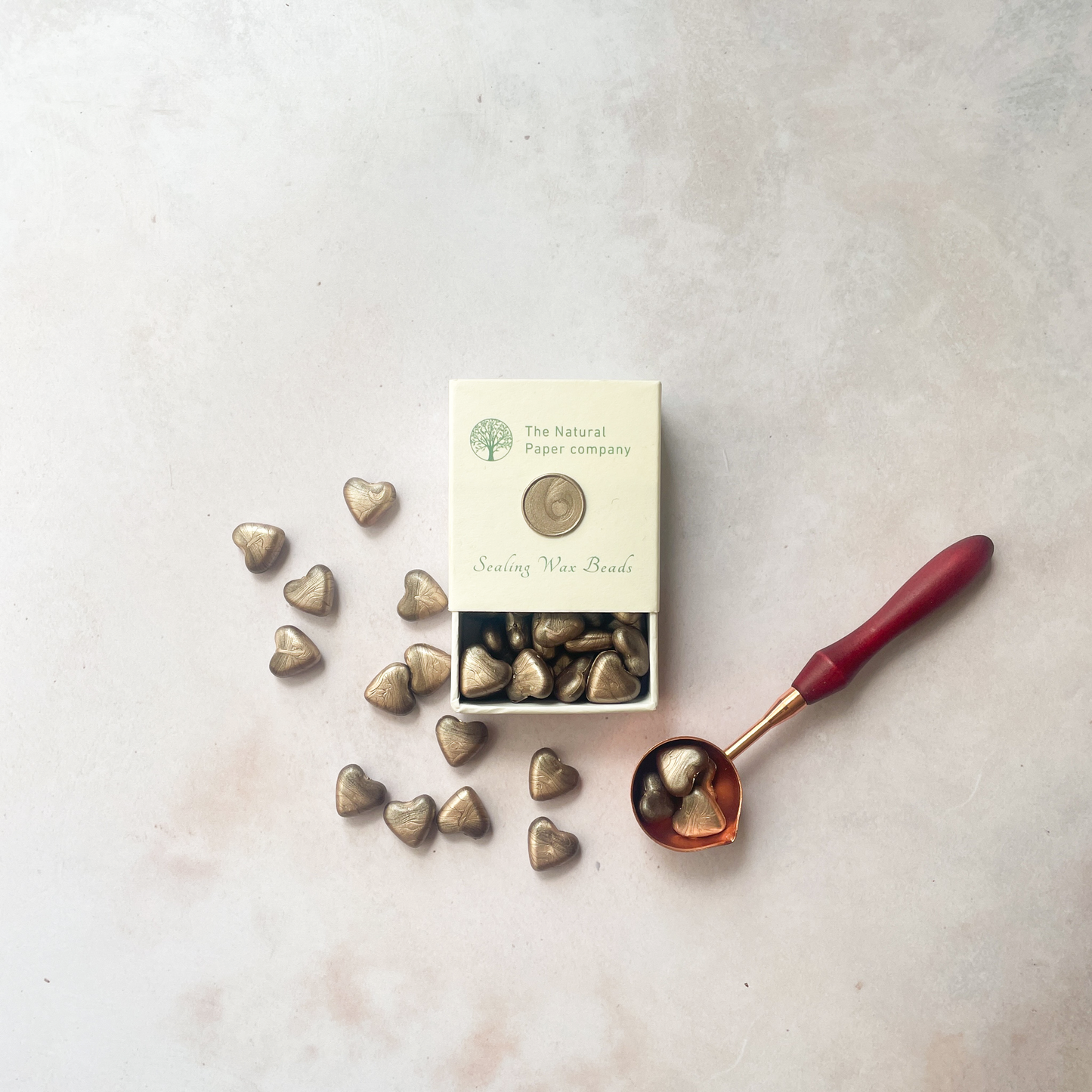 Sealing wax beads in champagne gold.  Eco friendly wax for wax seals.  Plastic free, paraffin free and biodegradable sealing wax beads in a box.  Metallic champagne gold colour.  By The Natural paper Company