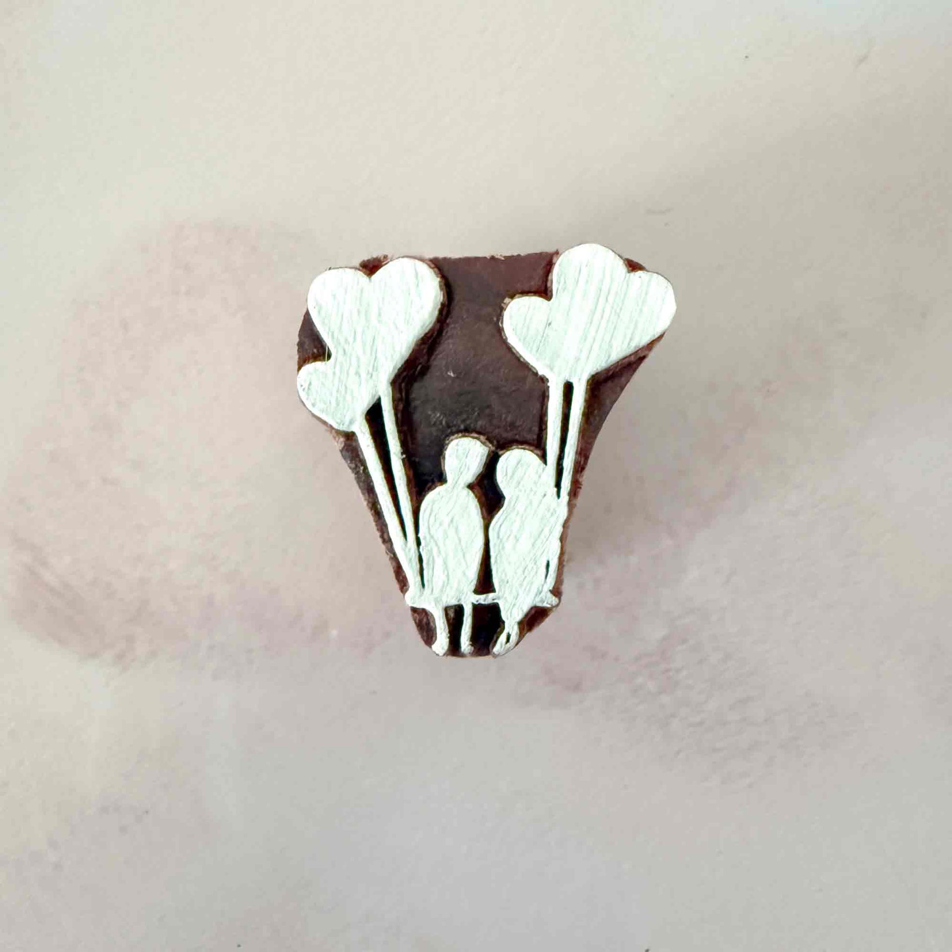 Banksy style wooden stamp with heart shaped balloons