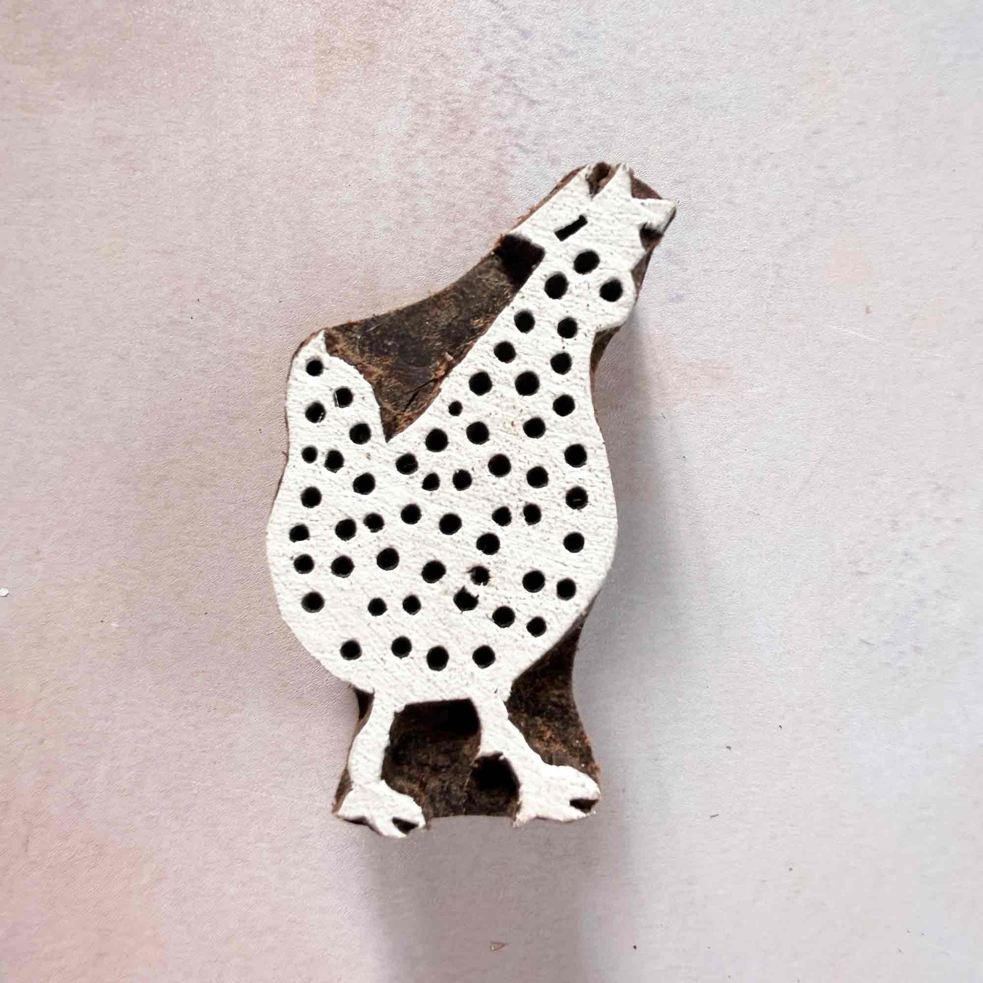 Indian wood block stamp — Cluck Chicken face-on view on soft pale background, plump dotted body with sweet outline, hand-carved wooden stamp, authentic traditional printing block from India
