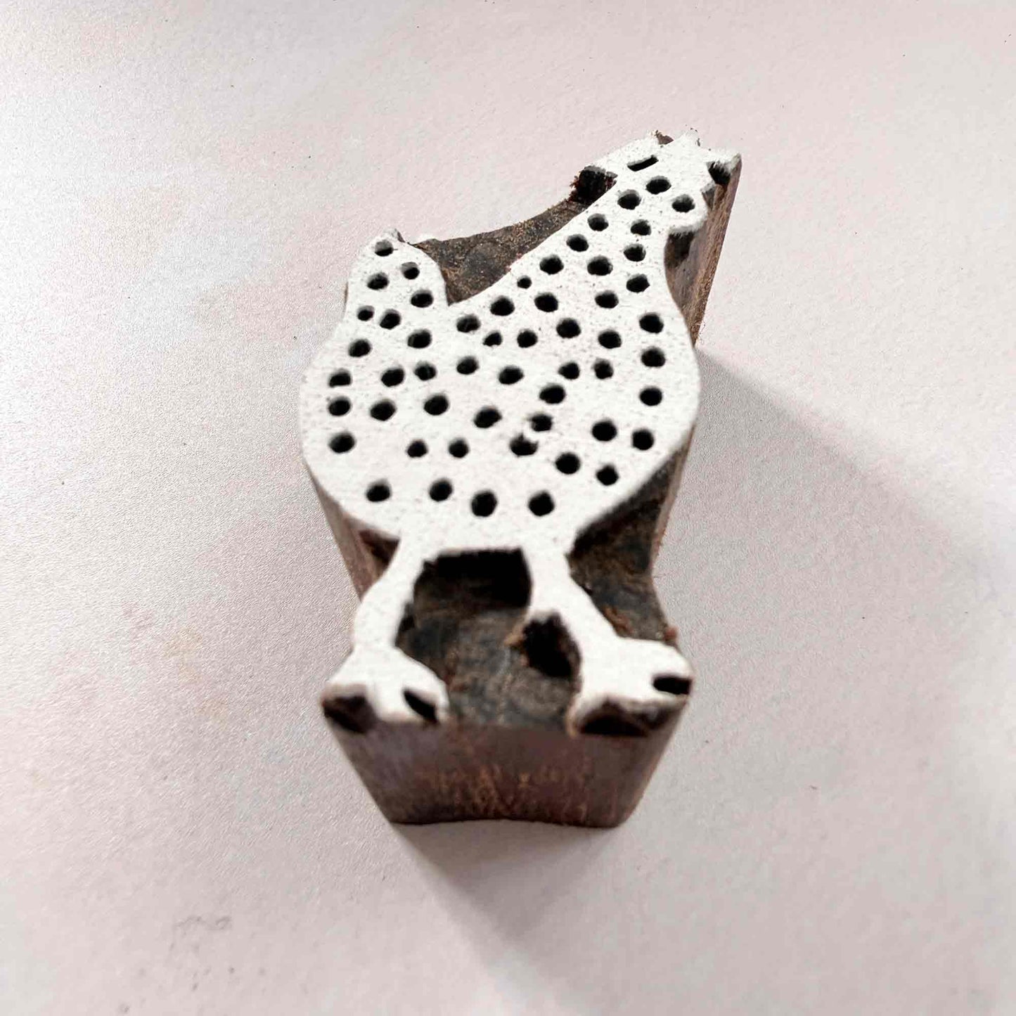Indian wood block stamp — Cluck spotted hen viewed from angle, showing carved depth and smooth hen shape texture, handcrafted wooden stamp, premium traditional printing block hardwood