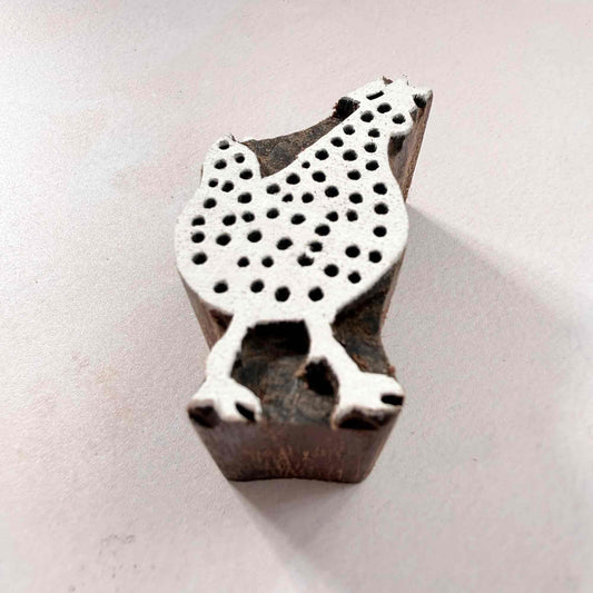 Indian wood block stamp — Cluck spotted hen viewed from angle, showing carved depth and smooth hen shape texture, handcrafted wooden stamp, premium traditional printing block hardwood