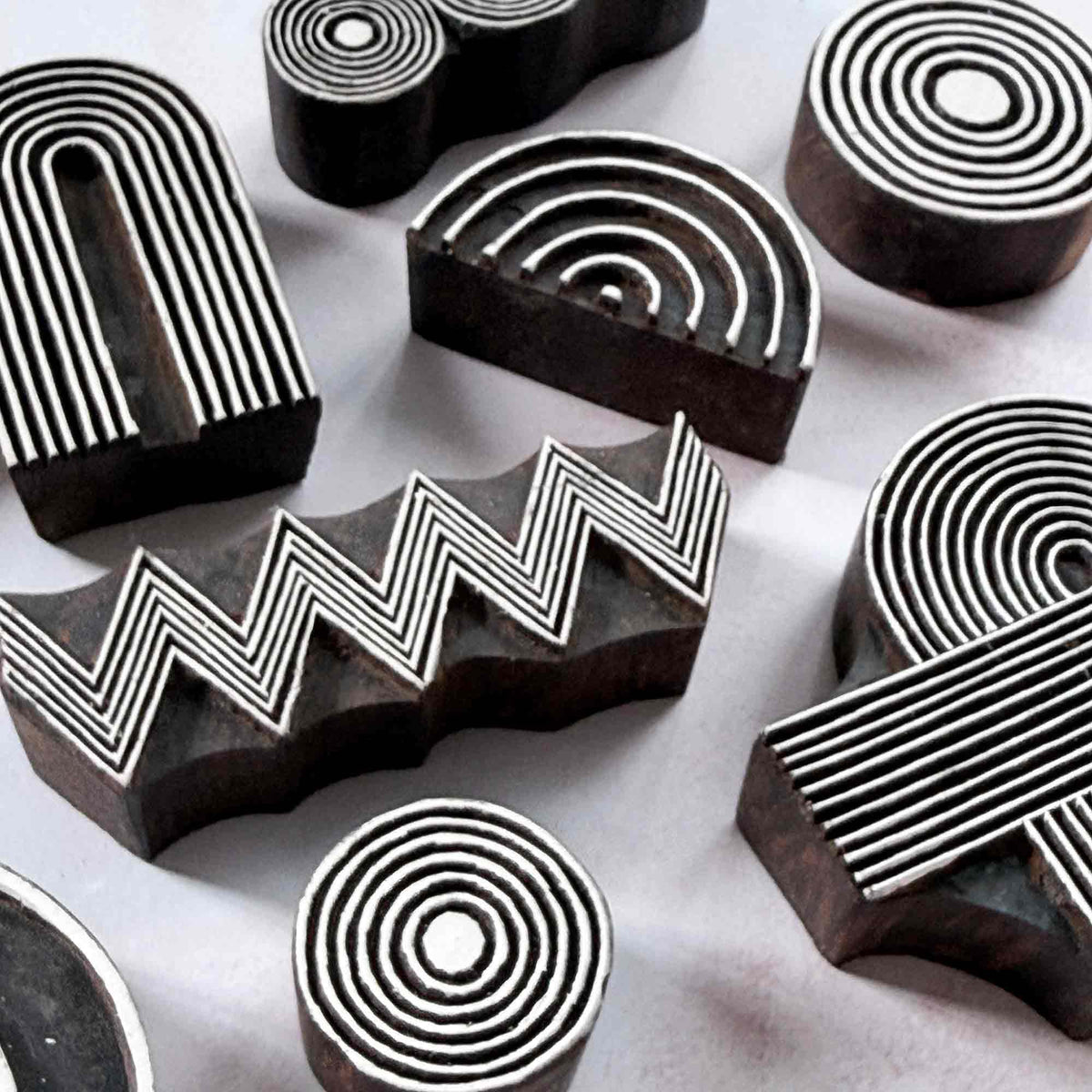 A collection of traditional printing blocks with geometric designs
