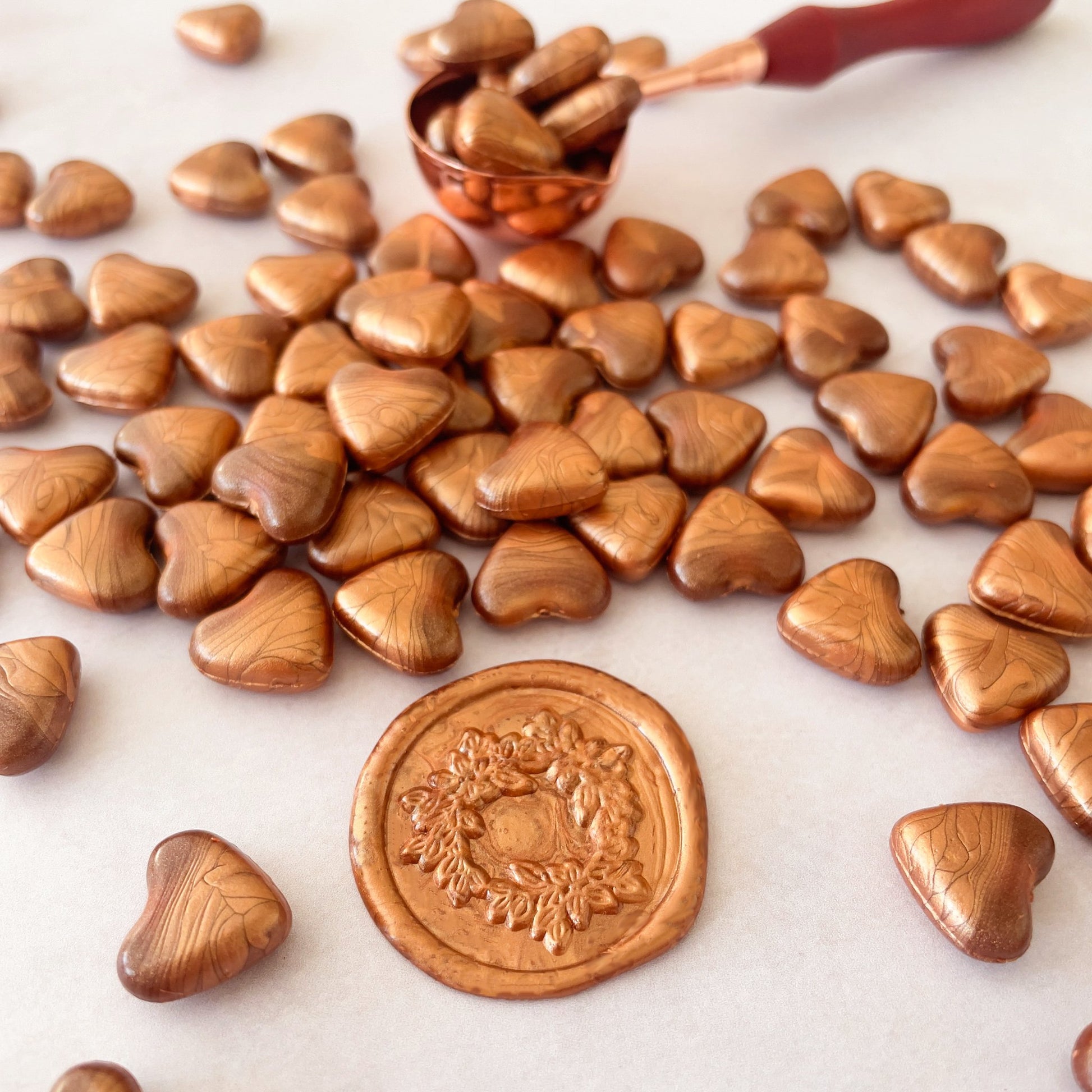 Small beads of sealing wax in copper.  Wax beads to make wax seals with a melting spoon and stamp.  by The Natural Paper Company