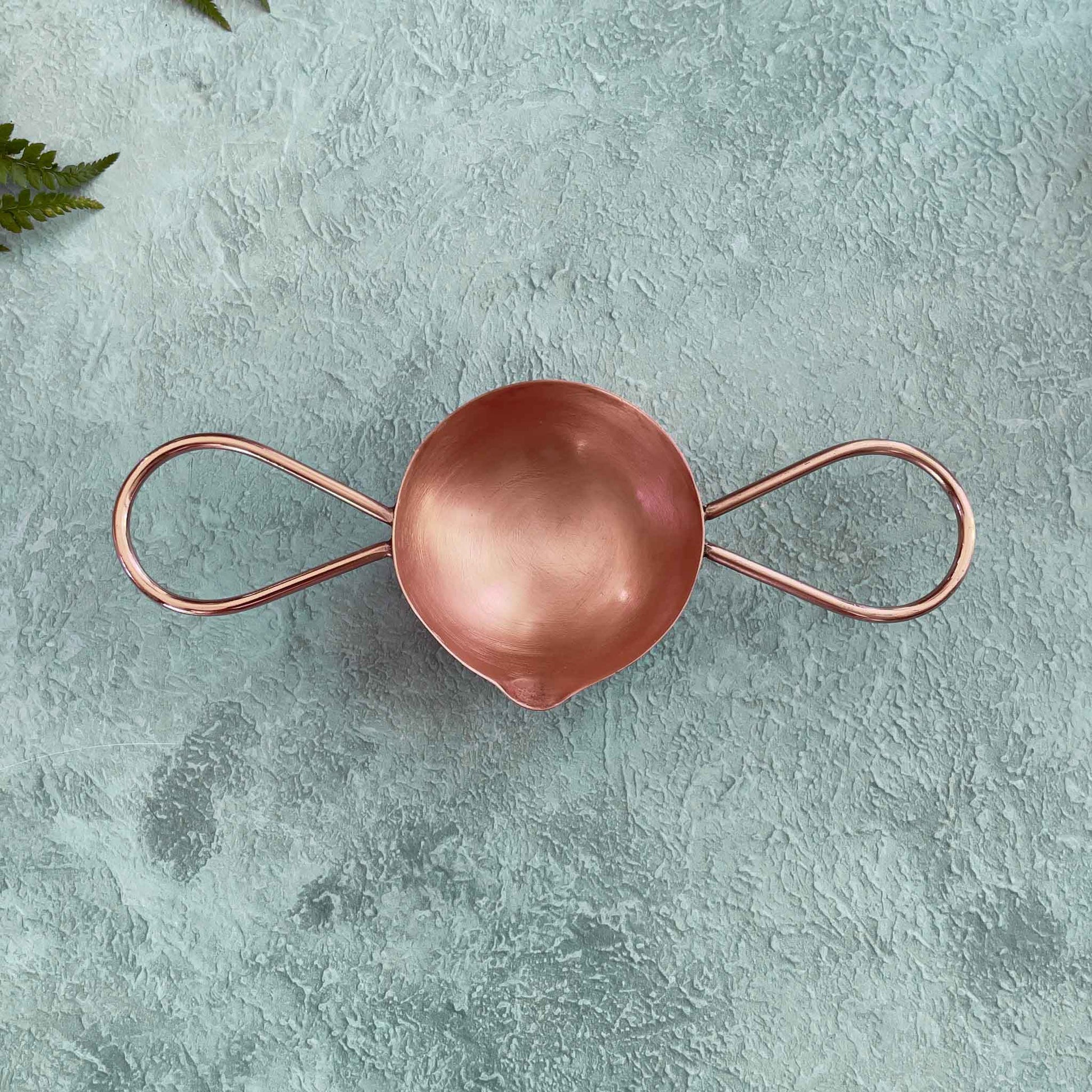 copper melting spoon with two handles.  Use with a candle flame to make wax seals