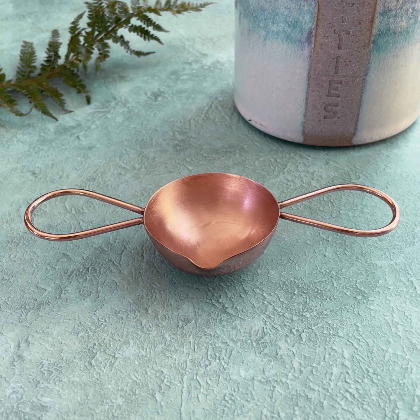 handmade copper sealing wax spoon with two handles.  Designed to use with a candle to make wax seals