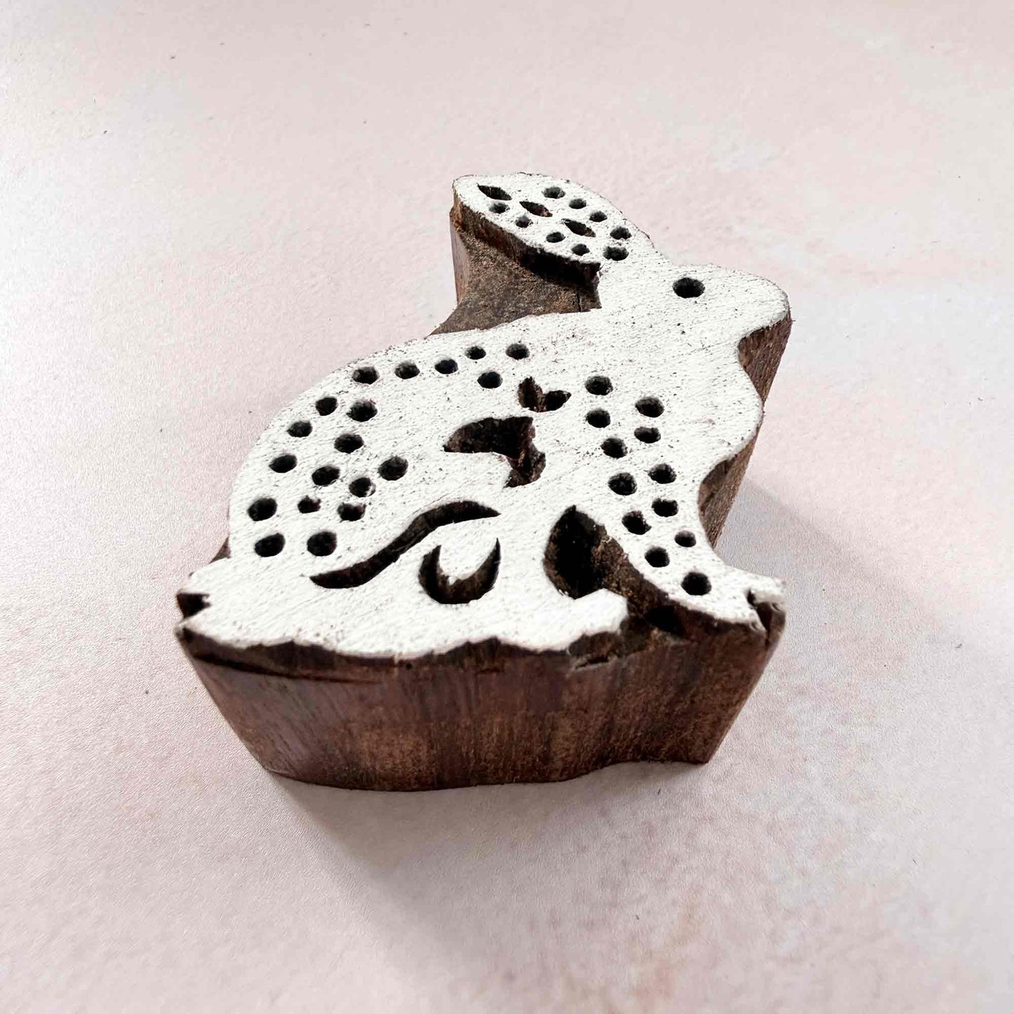 Indian wood block stamp — Cottontail spotted rabbit viewed from angle, showing carved depth and delicate spot texture, handcrafted wooden stamp, premium traditional printing block hardwood