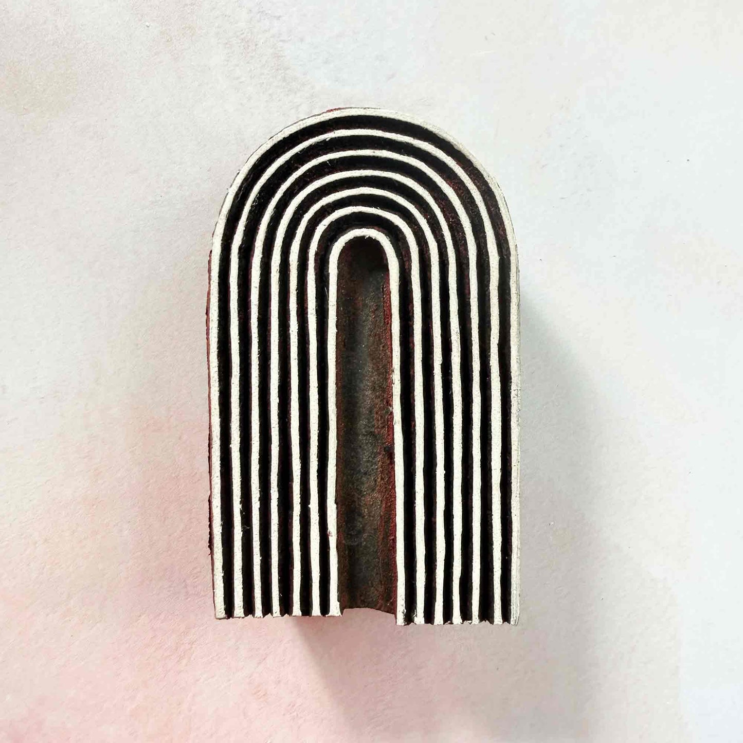 Cove Indian wood block stamp — modern curved arch design on pale background