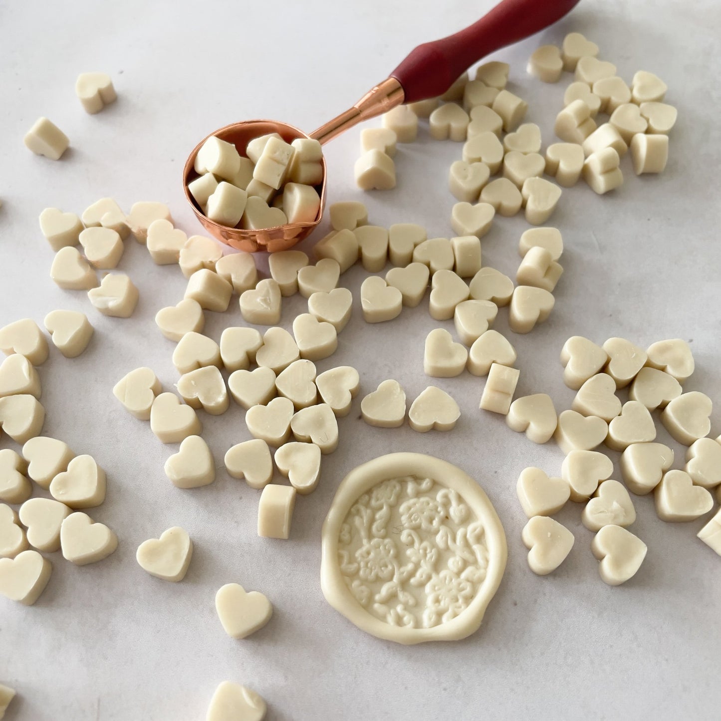 Sealing wax beads in cream.  Use these small beads of wax to make wax seals.  Eco friendly wax by The Natural Paper Company