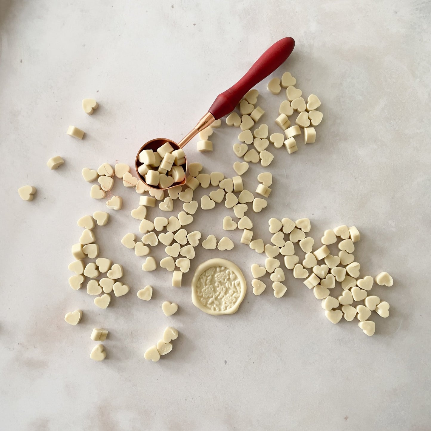 Heart shaped beads of sealing wax to make wax seals.  Cream sealing wax to use with a melting spoon and stamp.  Plastic free, paraffin free and biodegradable wax by The Natural Paper Company