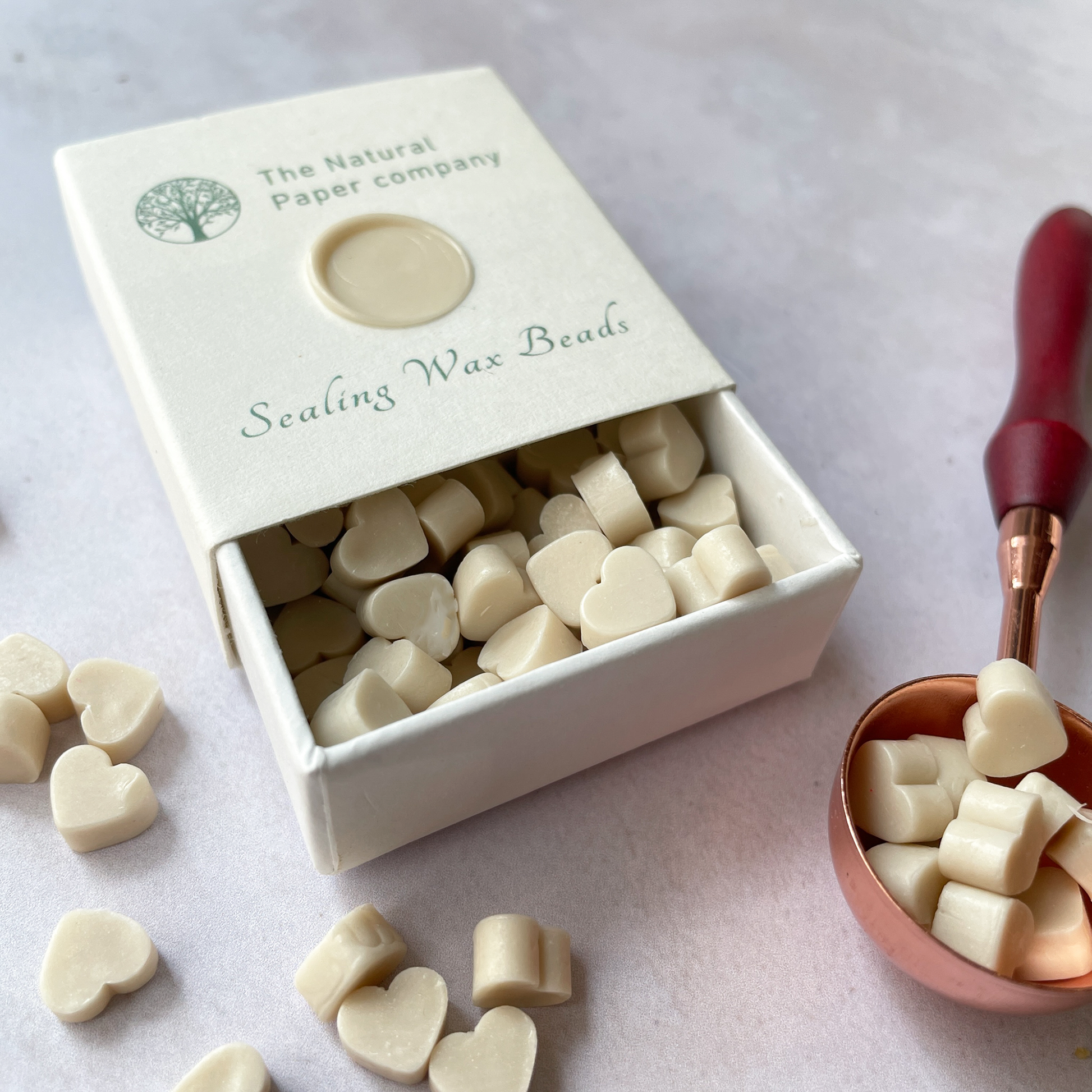 Box of sealing wax beads in cream.  Small wax beads for making wax stamps and wax seals.
