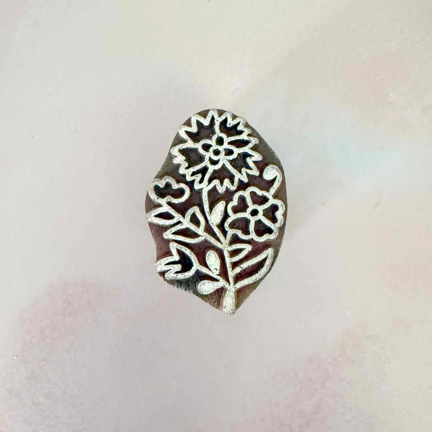 small wooden stamp with flower design
