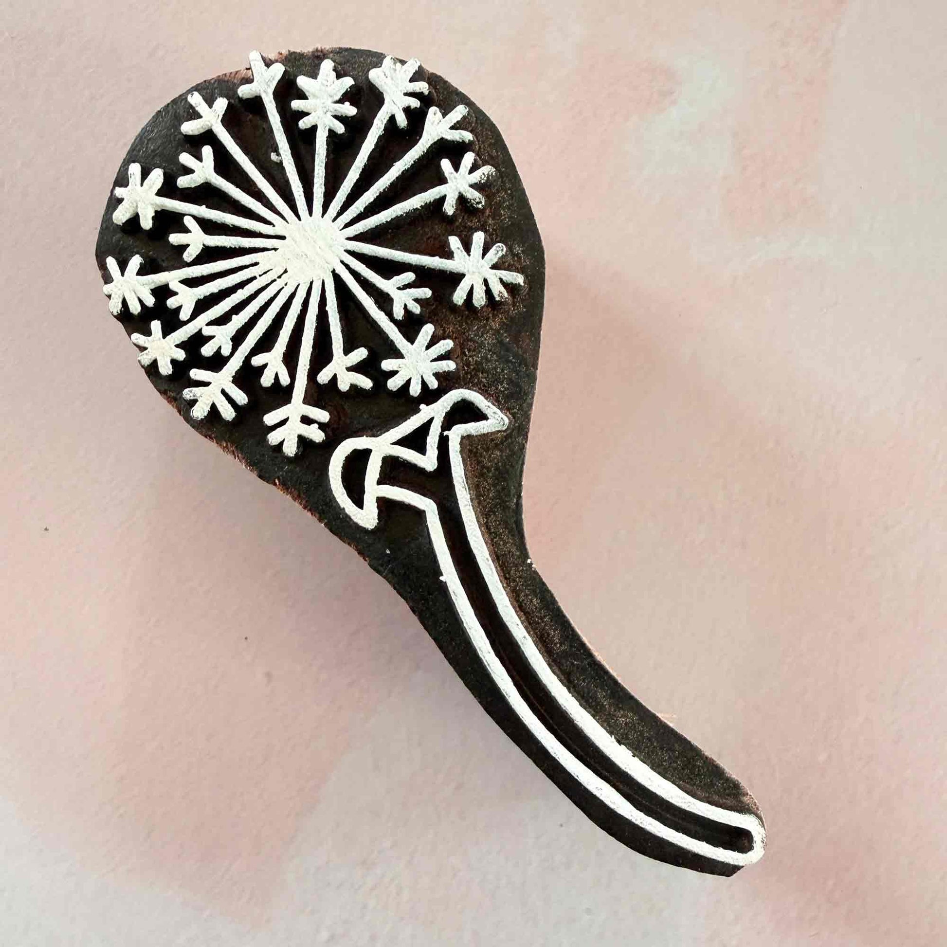 decorative wooden stamp with a dandelion clock pattern