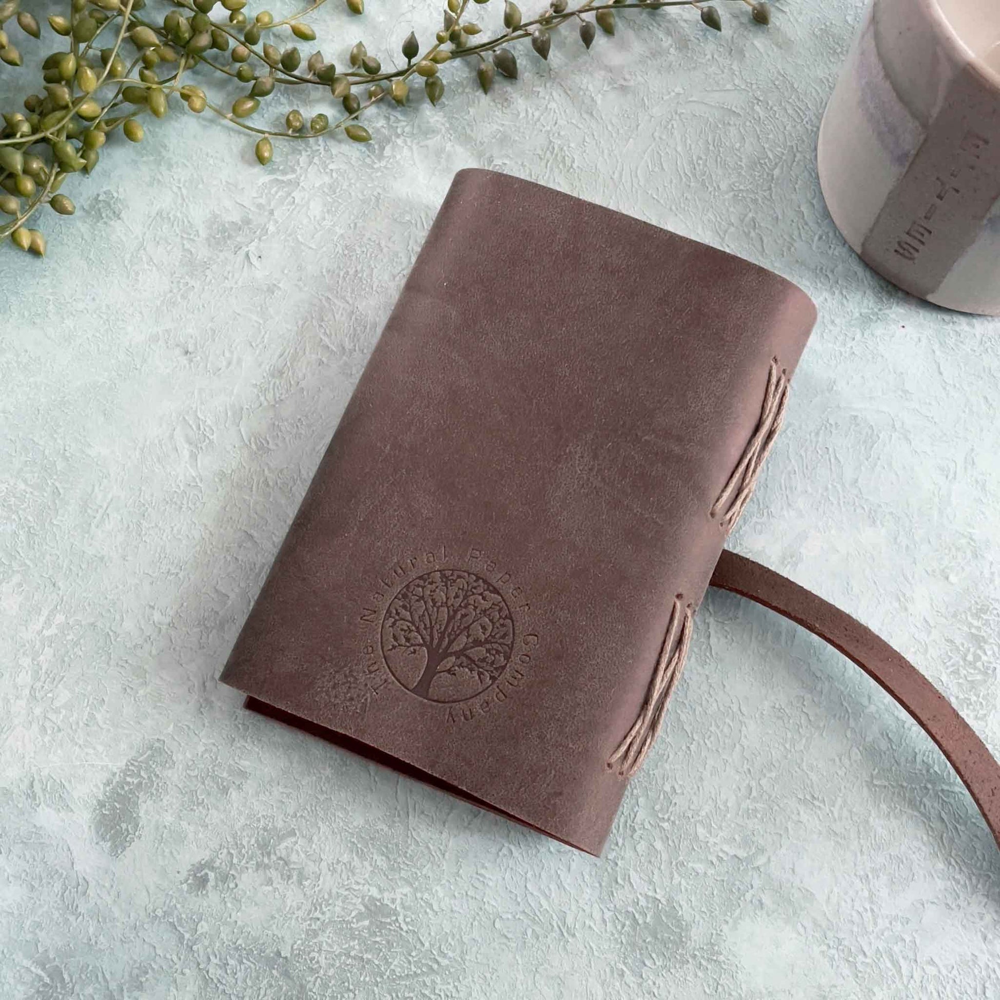 handmade notebook in dark brown leather with recycled paper pages