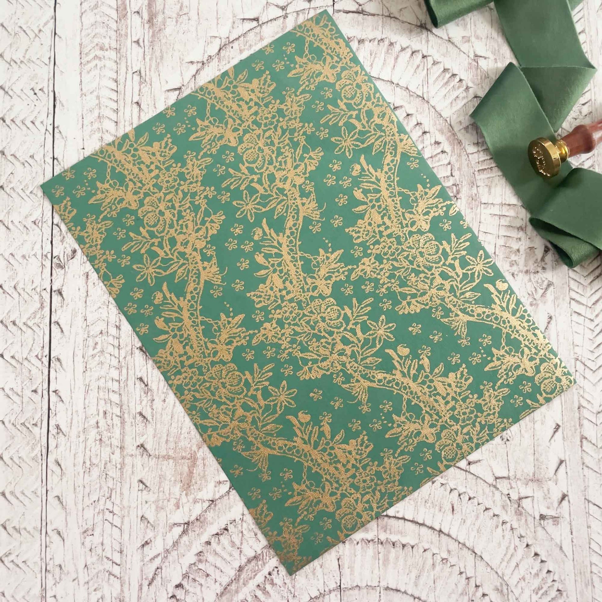 Decorative recycled paper with floral pwttern.  Green and gold cotton rag paper